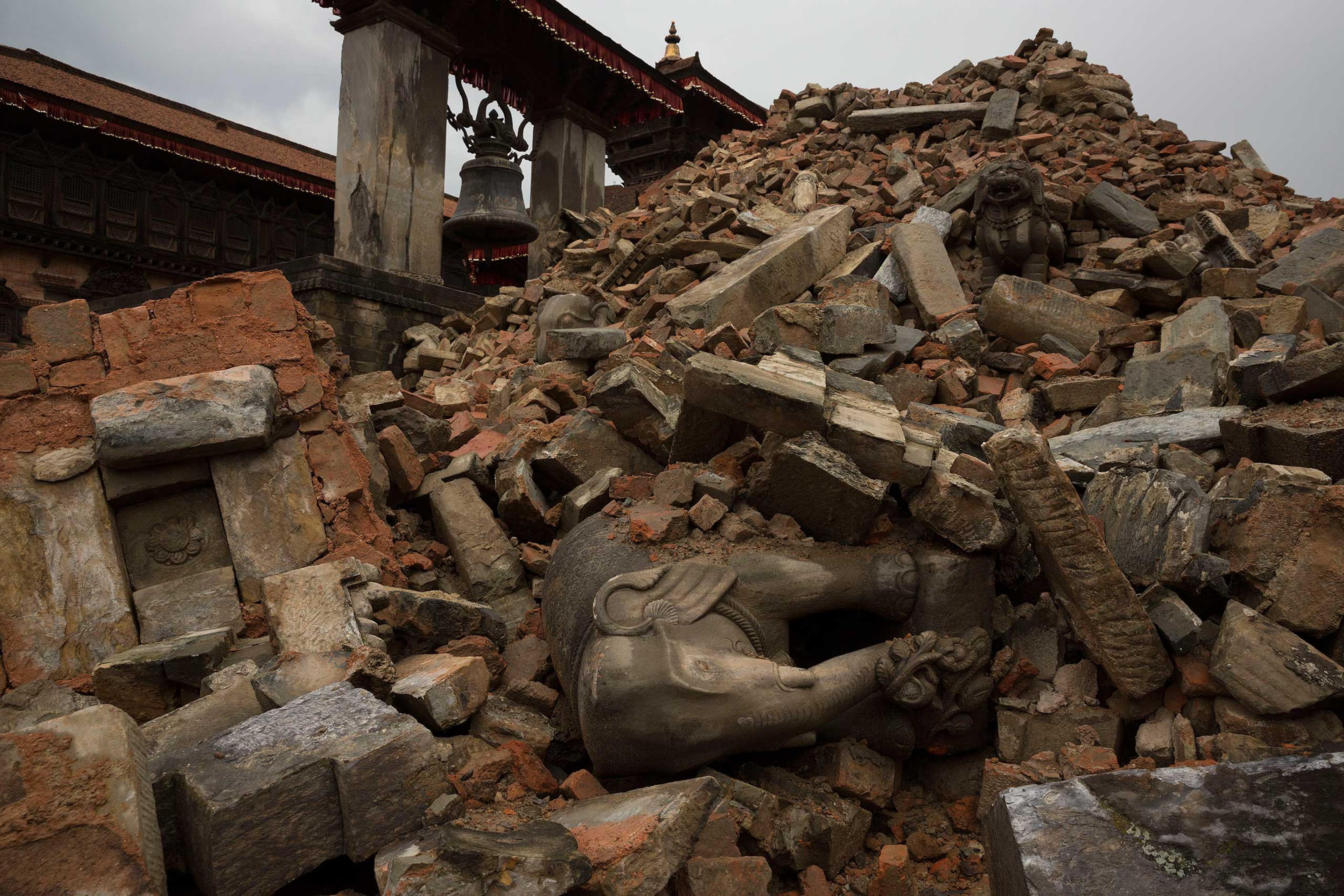 Nepal earthquake. Bhaktapur. A city near Katmandu. People reclaiming their possessions from the wreckage. A man who had been buried and died being pulled out of the wreckage by there Nepali Army rescue team. Sculpture of elephant in ruins of an ancient,