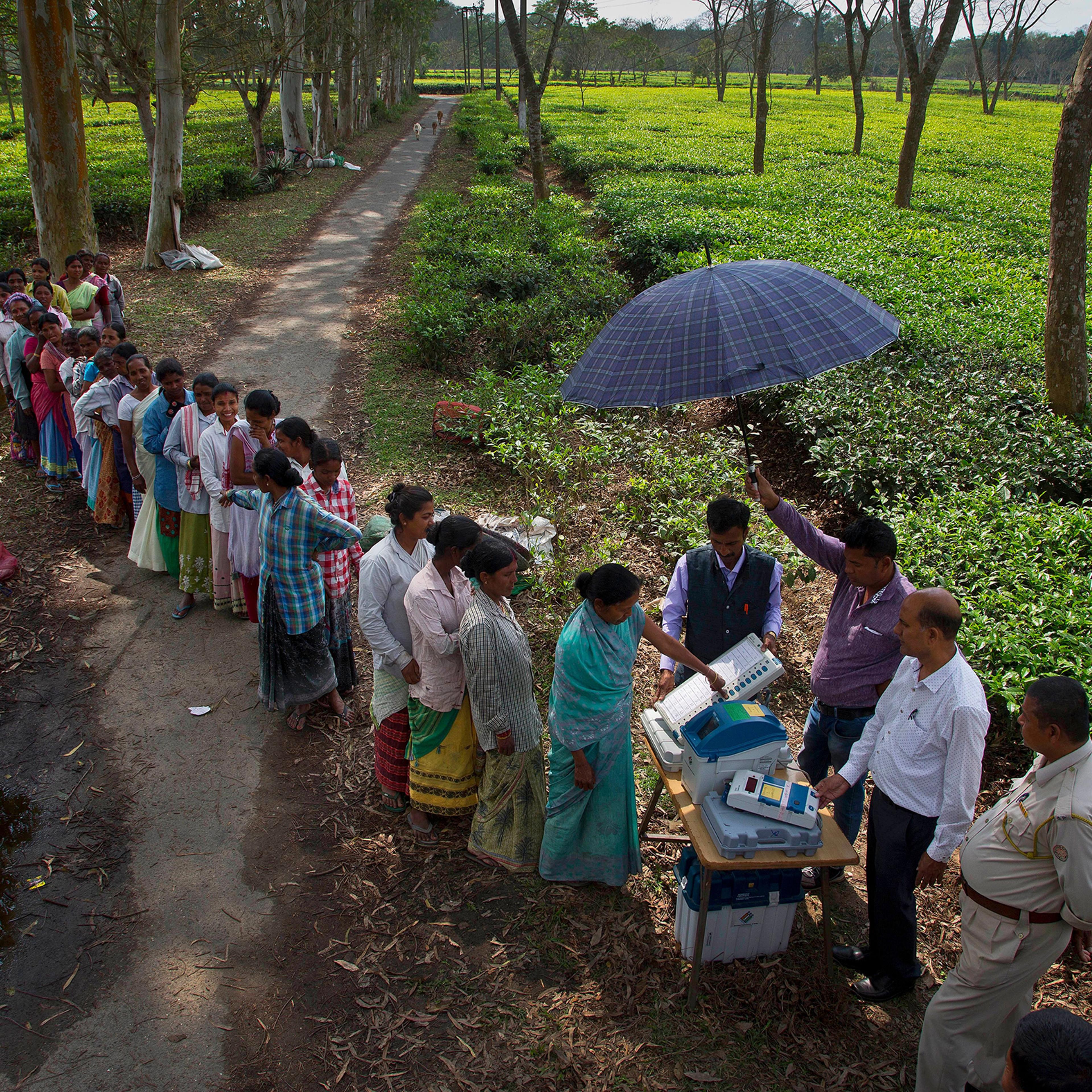 A woman in Jorhat, India, casts her vote on a demo VVPAT vending machine, which allows voters to check that their votes are being cast as intended. The system will be used in the upcoming national election.