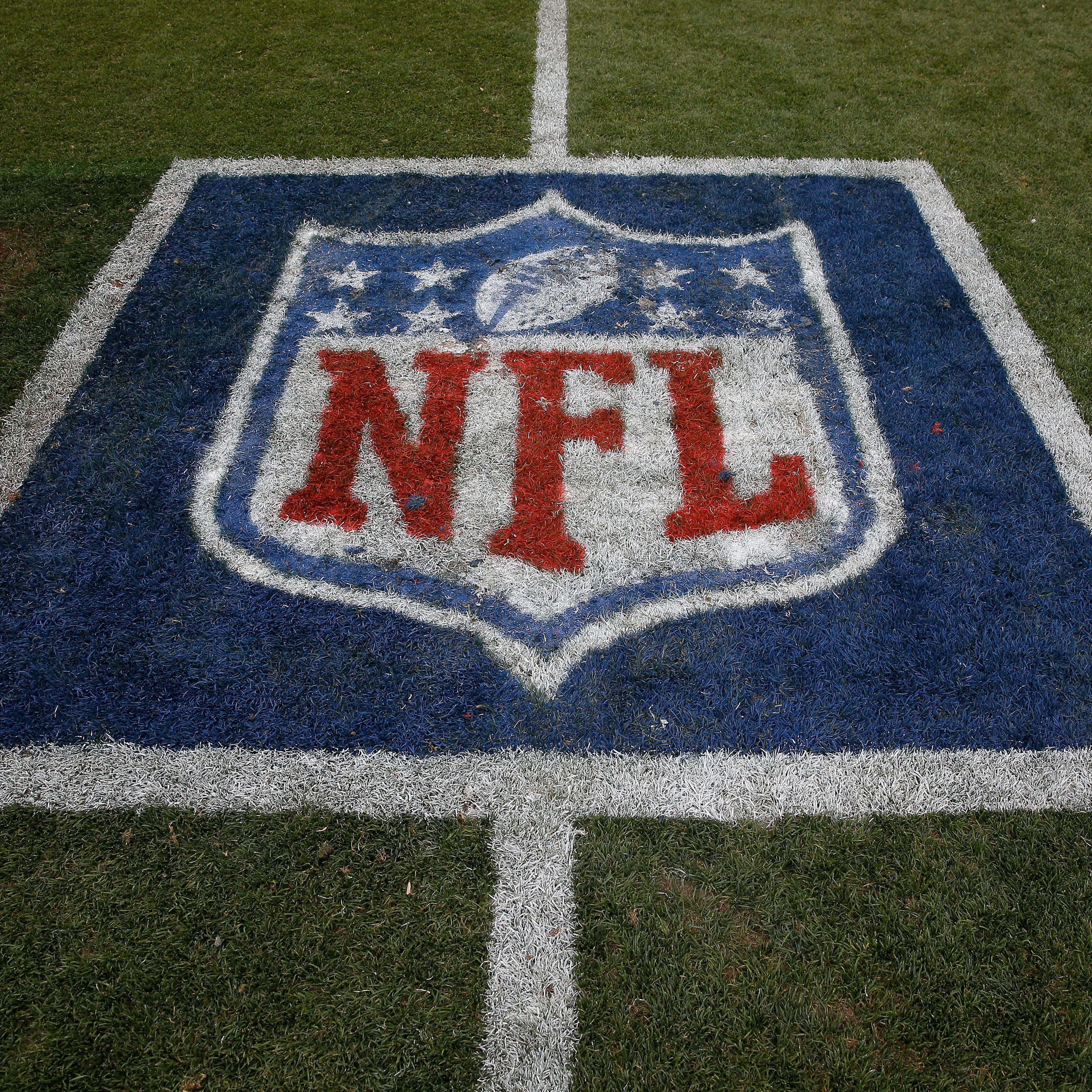 The NFL logo is displayed on the turf on September 14, 2014.