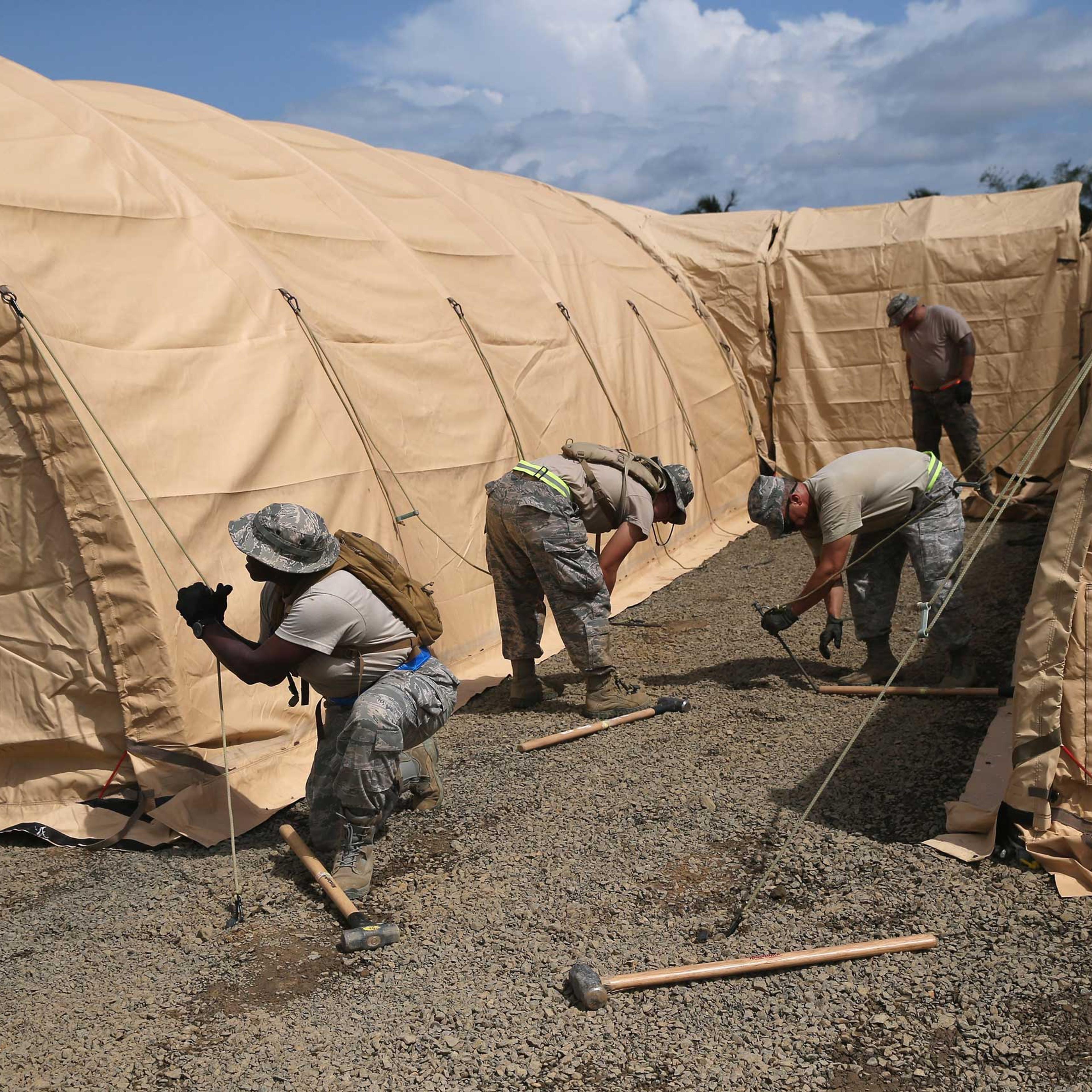 U.S. Air Force personnel put up tents to house a 25-bed U.S.-built hospital for sick Liberian health workers as part in Operation United Assistance on Oct. 9, 2014 in Monrovia, Liberia.