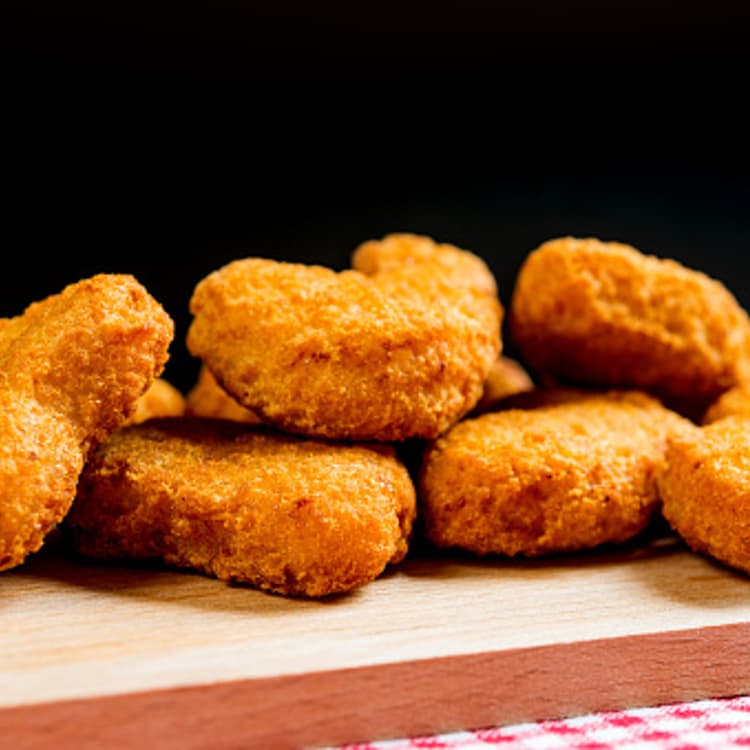 Close-up of chicken nuggets on cutting board