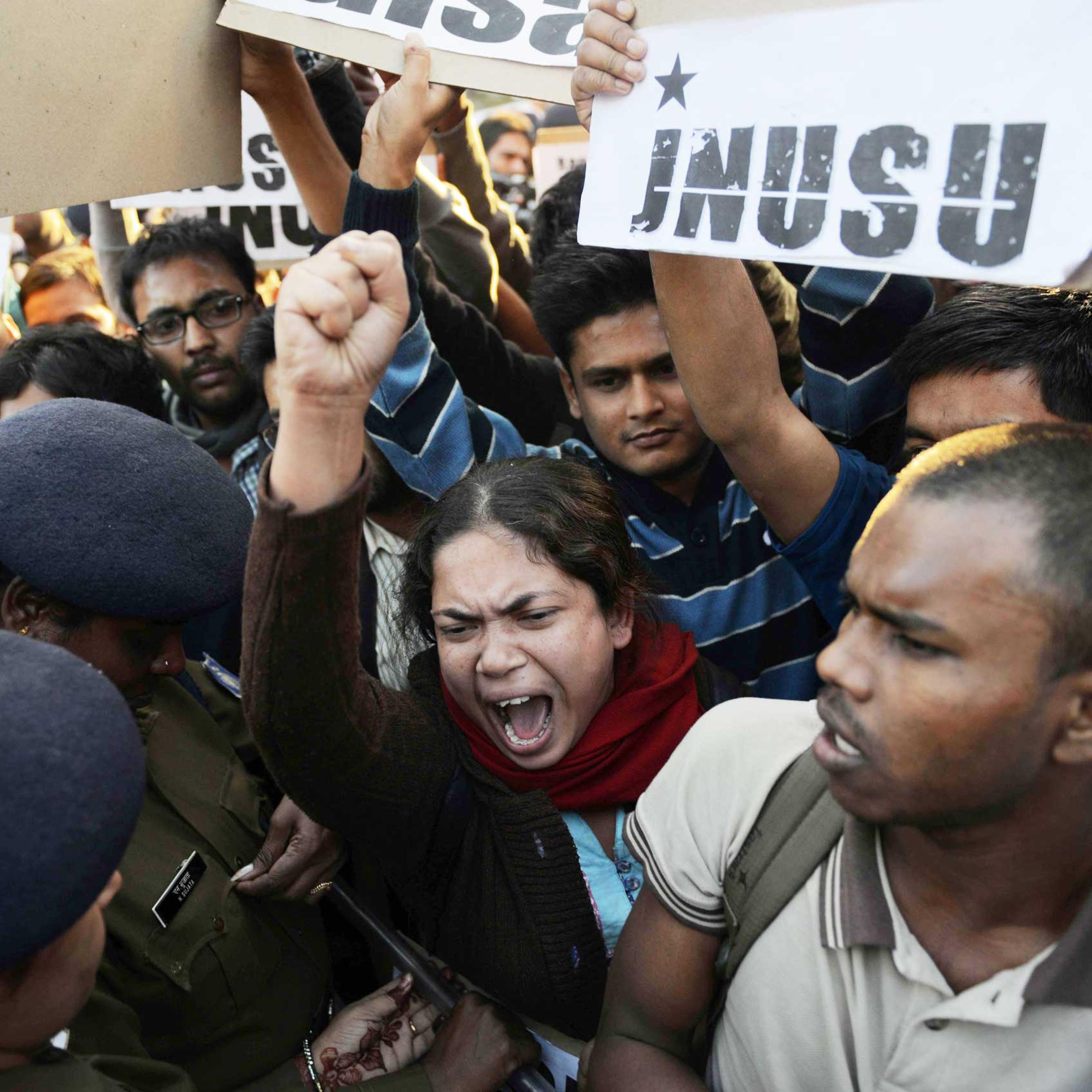 Indian residents hold placards and chant slogans as they take part in a protest against the alleged rape of a passenger by an Uber driver in New Delhi on Dec. 7, 2014.