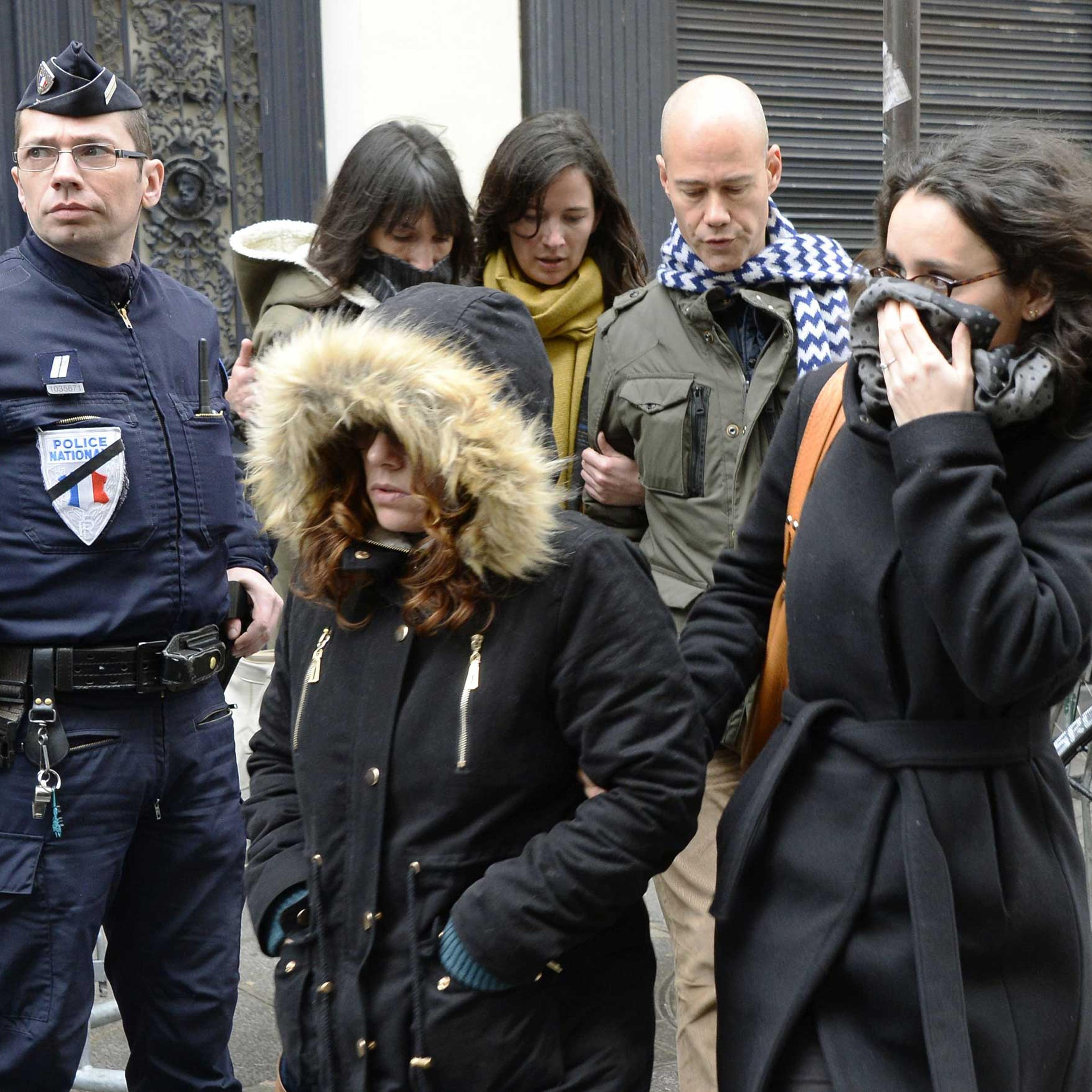 Staff arrive to attend an editorial meeting of French satirical weekly newspaper Charlie Hebdo and Liberation, Jan. 9, 2015 in Paris.