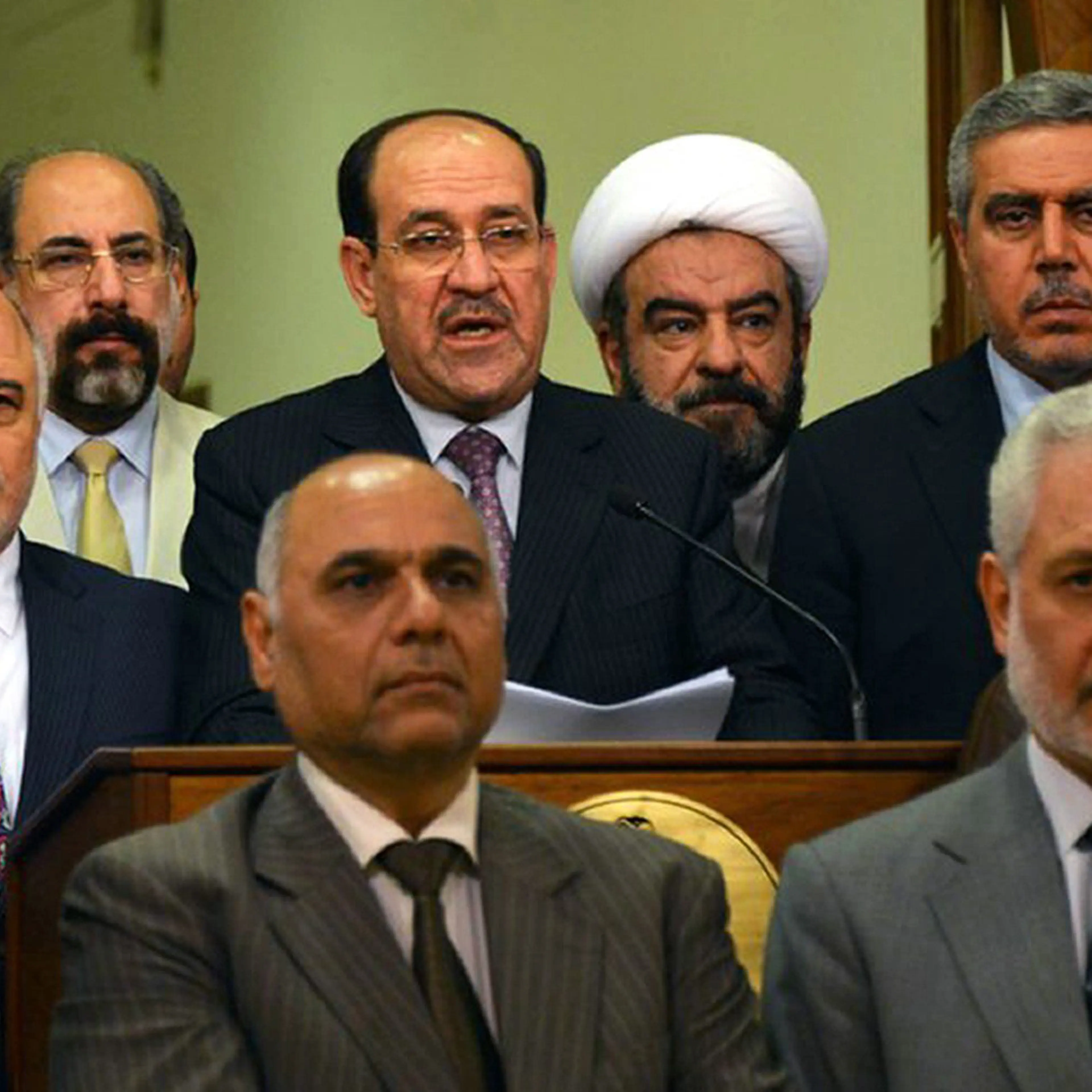 Outgoing Iraqi prime minister Nuri al-Maliki, alongside his designated successor Haidar al-Abadi, delivering a speech in which he announced withdrawing his candidacy for a third term in a photo released Aug. 14, 2014,
