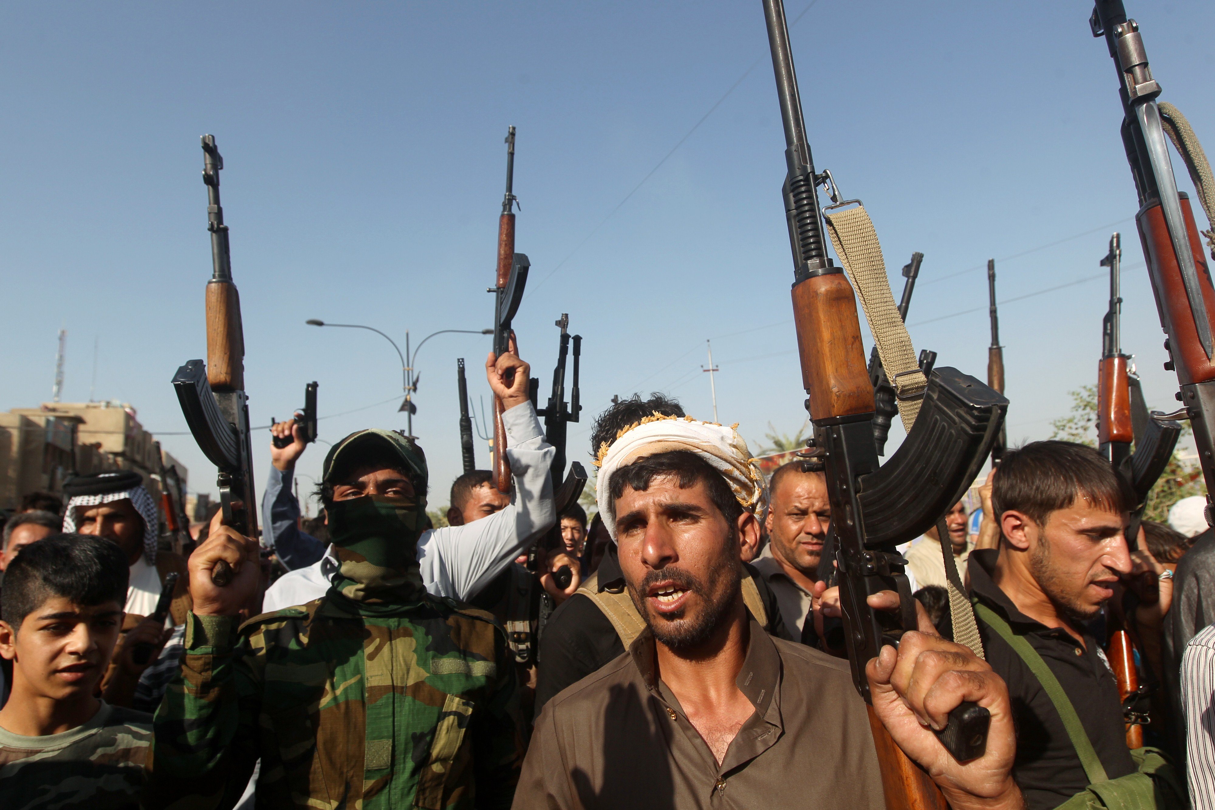 Iraqi tribesmen hold up their weapons as they gather to show their readiness to join Iraqi security forces in the fight against Jihadist militants who have taken over several northern Iraqi cities on June 16, 2014 in the capital Baghdad.