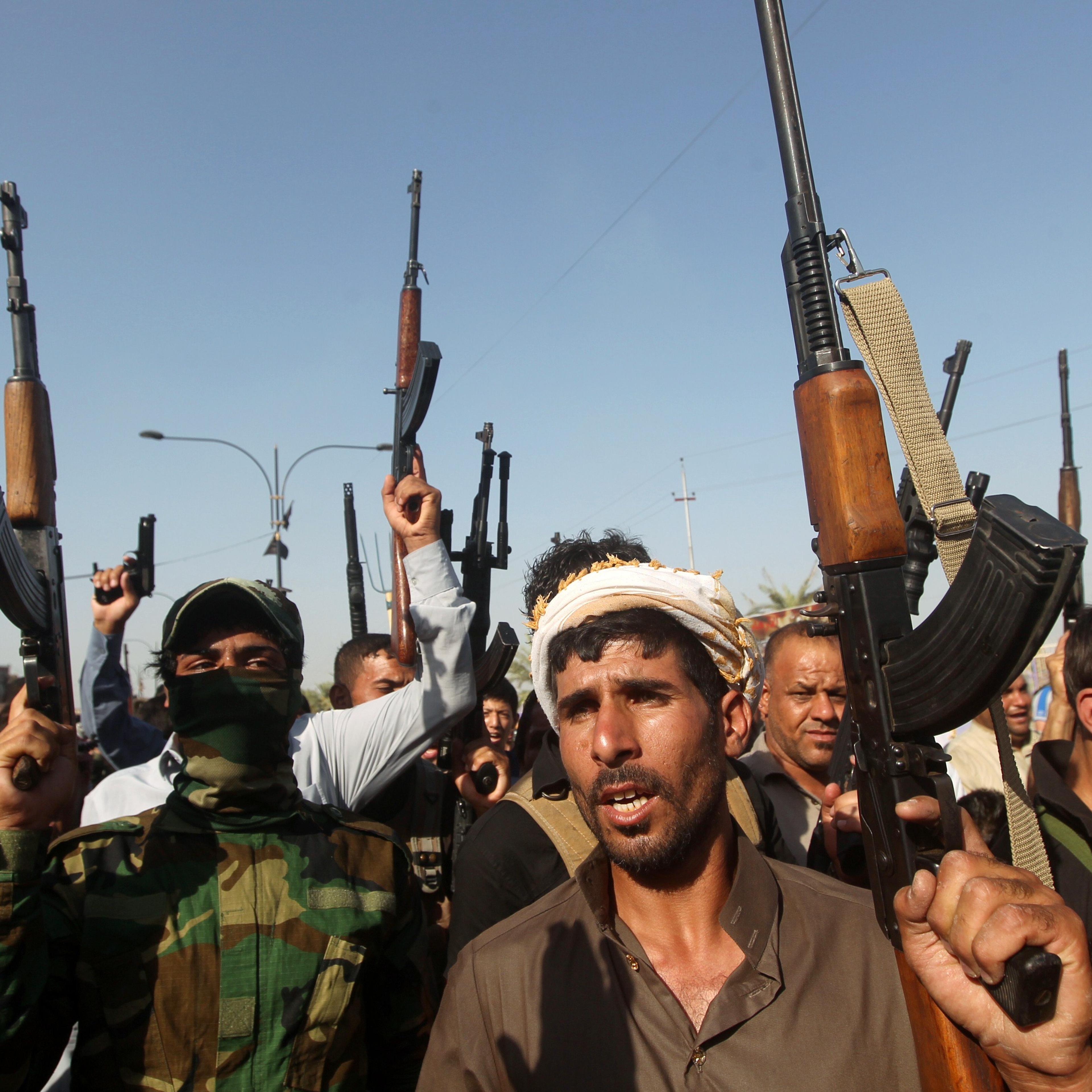 Iraqi tribesmen hold up their weapons as they gather to show their readiness to join Iraqi security forces in the fight against Jihadist militants who have taken over several northern Iraqi cities on June 16, 2014 in the capital Baghdad.