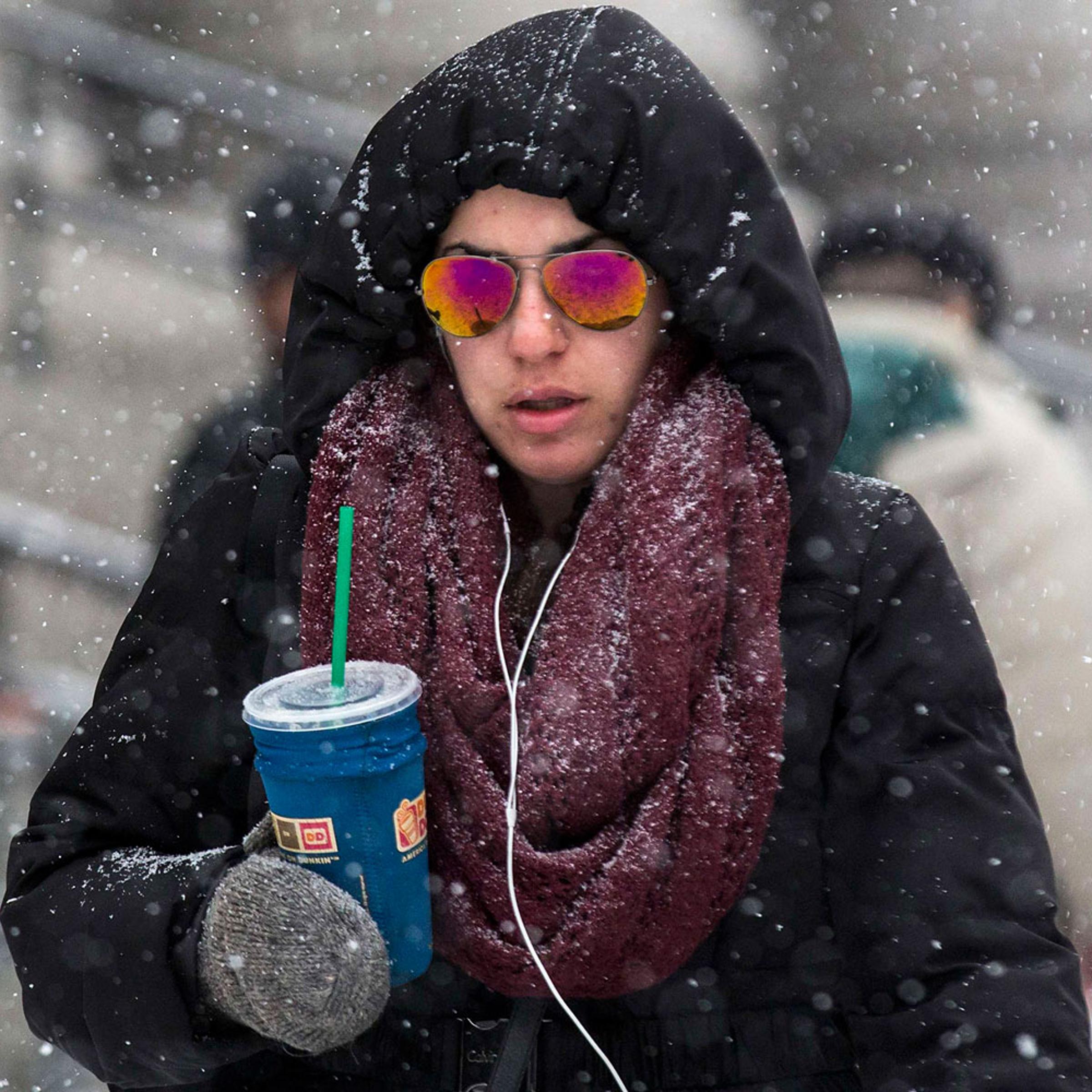 A woman walks through the blowing snow in the downtown area of New York