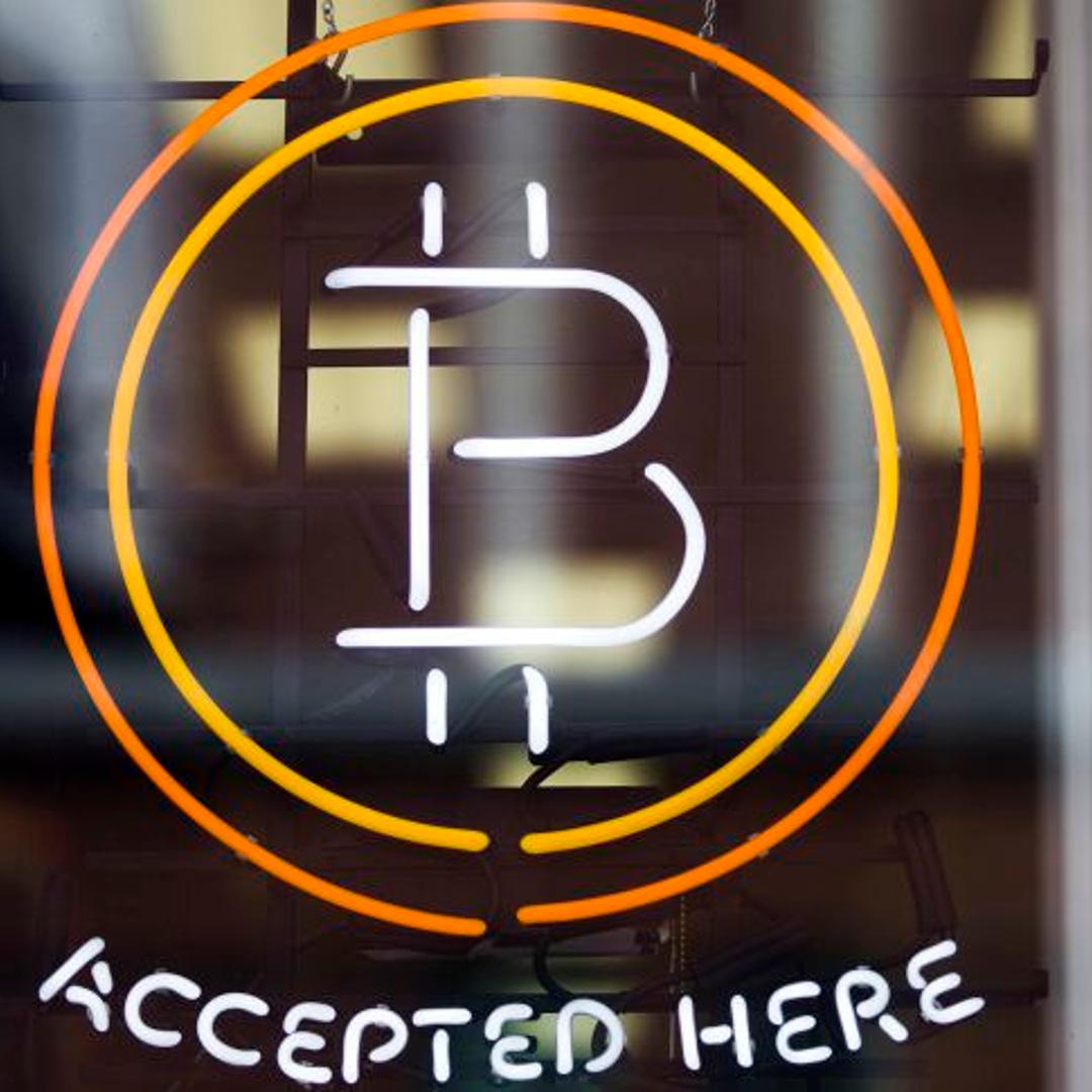 A Bitcoin sign is seen in a window in Toronto