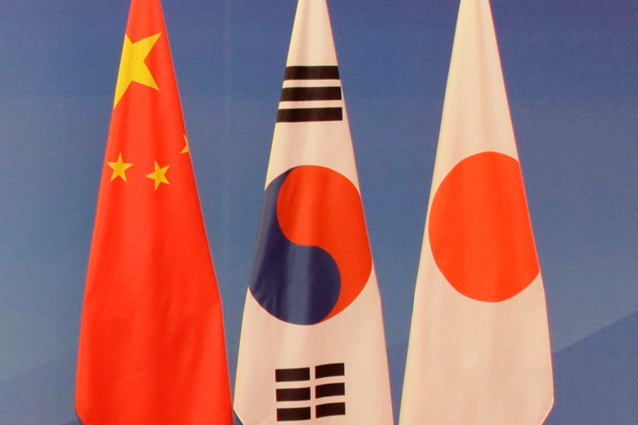 The flags of China, South Korea, and Japan.