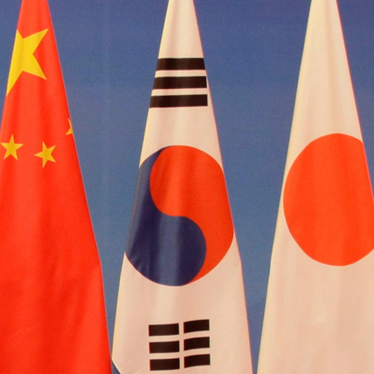 The flags of China, South Korea, and Japan.