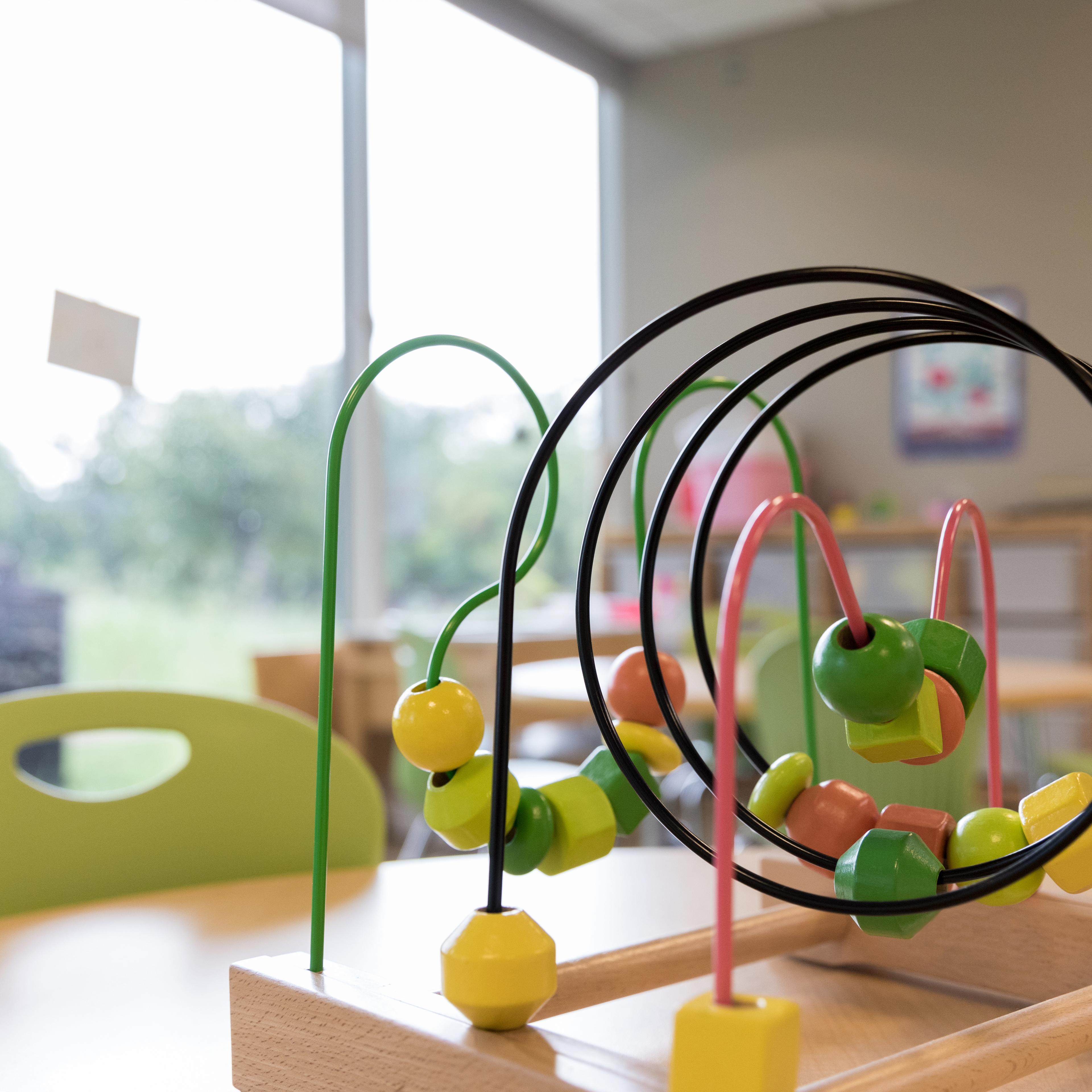 Close up photo bead puzzle in empty kindergarten classroom