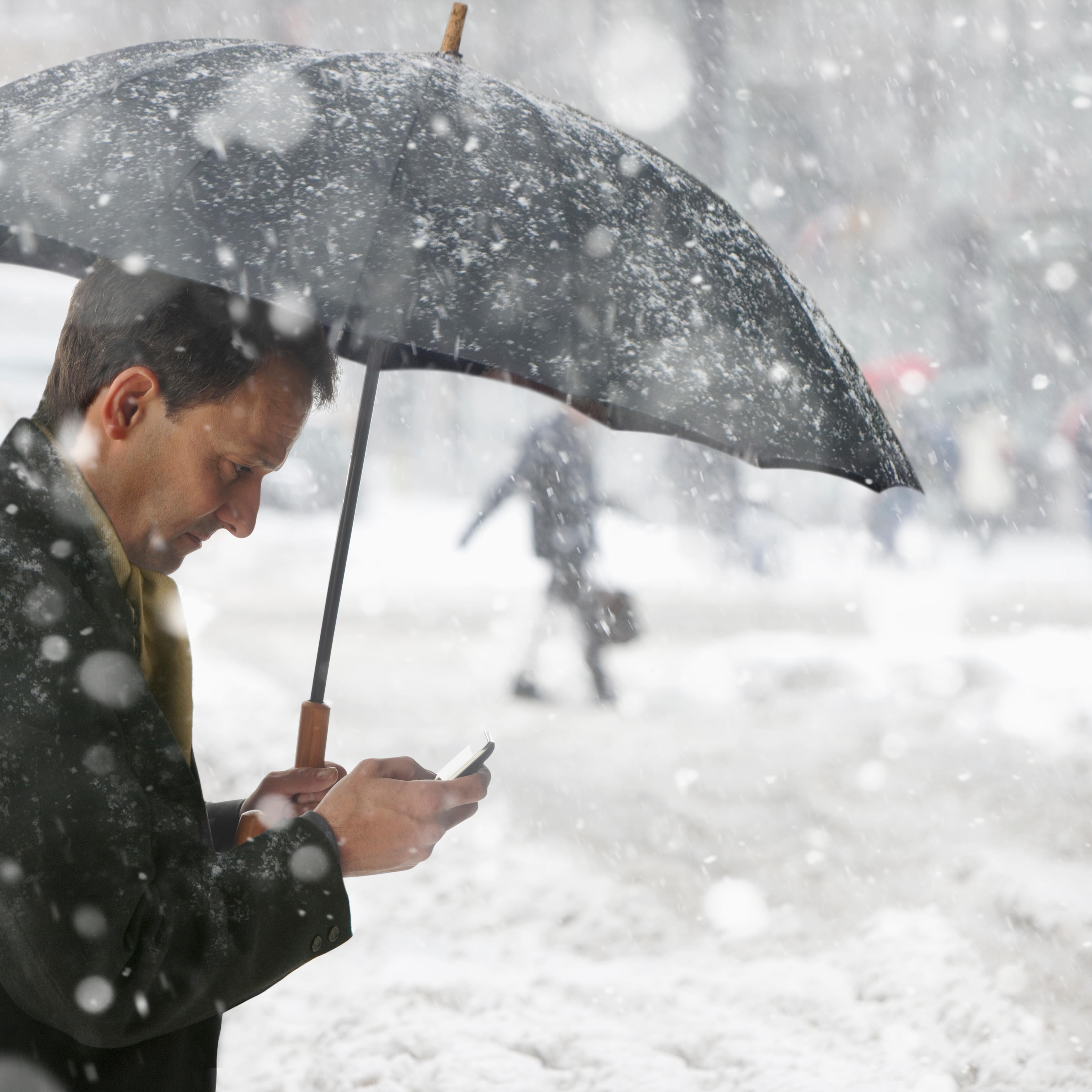 Man checking phone while in the snow