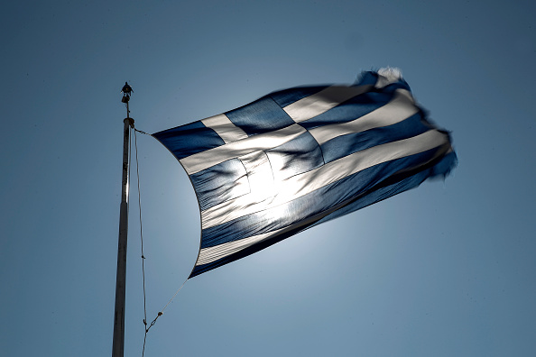 A Greek national flag flies in Athens on July 8, 2015.