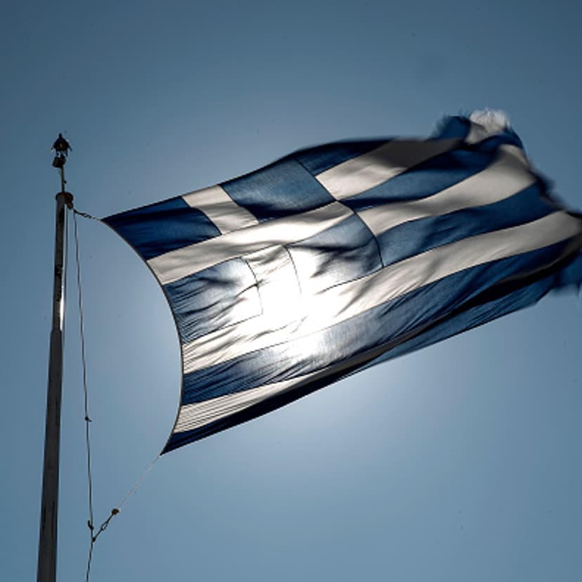 A Greek national flag flies in Athens on July 8, 2015.