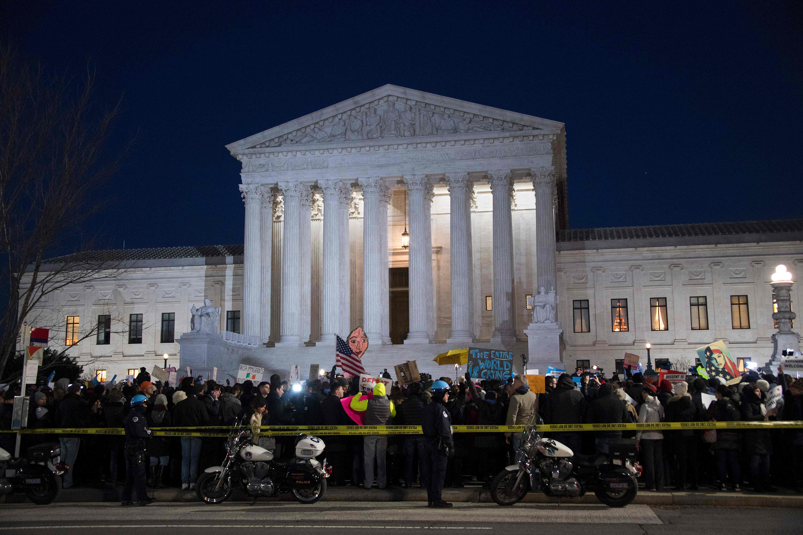 Demonstrators gather outside the US Supreme Court demanding US President Donald Trump reverse hateful anti-refugee and anti-immigration executive orders in Washington, DC, January 30, 2017. / AFP PHOTO / JIM WATSONJIM WATSON/AFP/Getty Images
