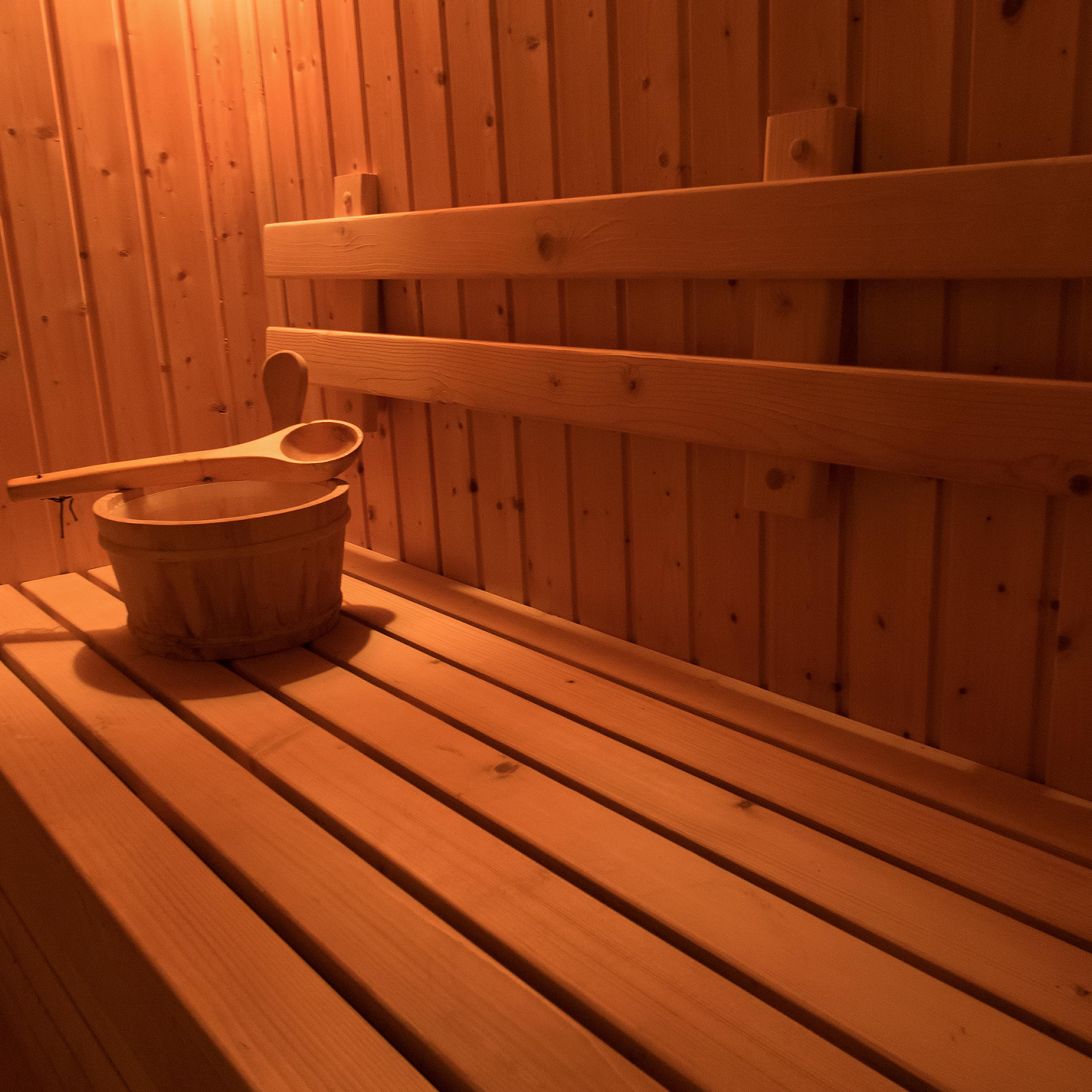 Wooden sauna with traditional sauna accessories for healthy and medical.