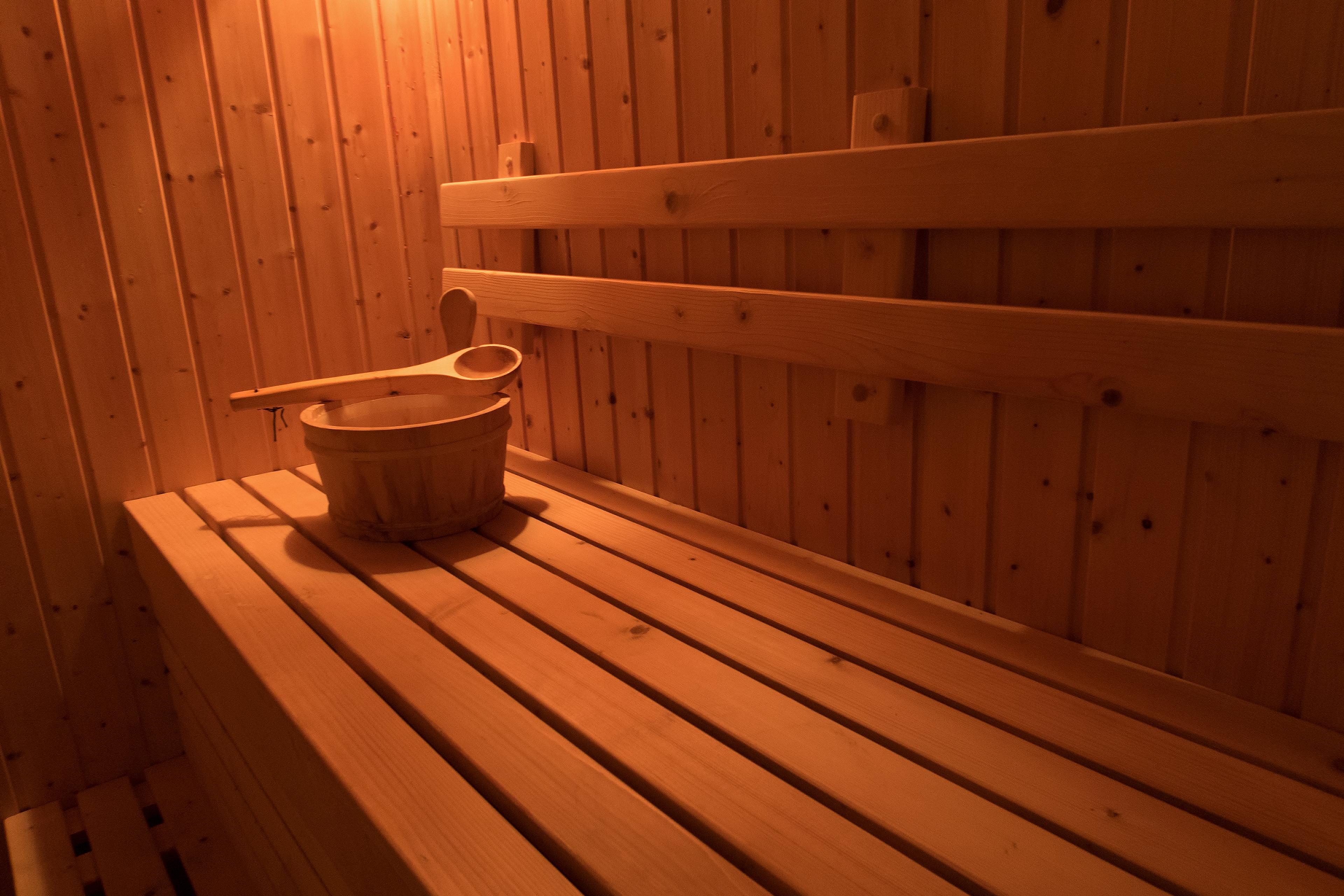 Wooden sauna with traditional sauna accessories for healthy and medical.