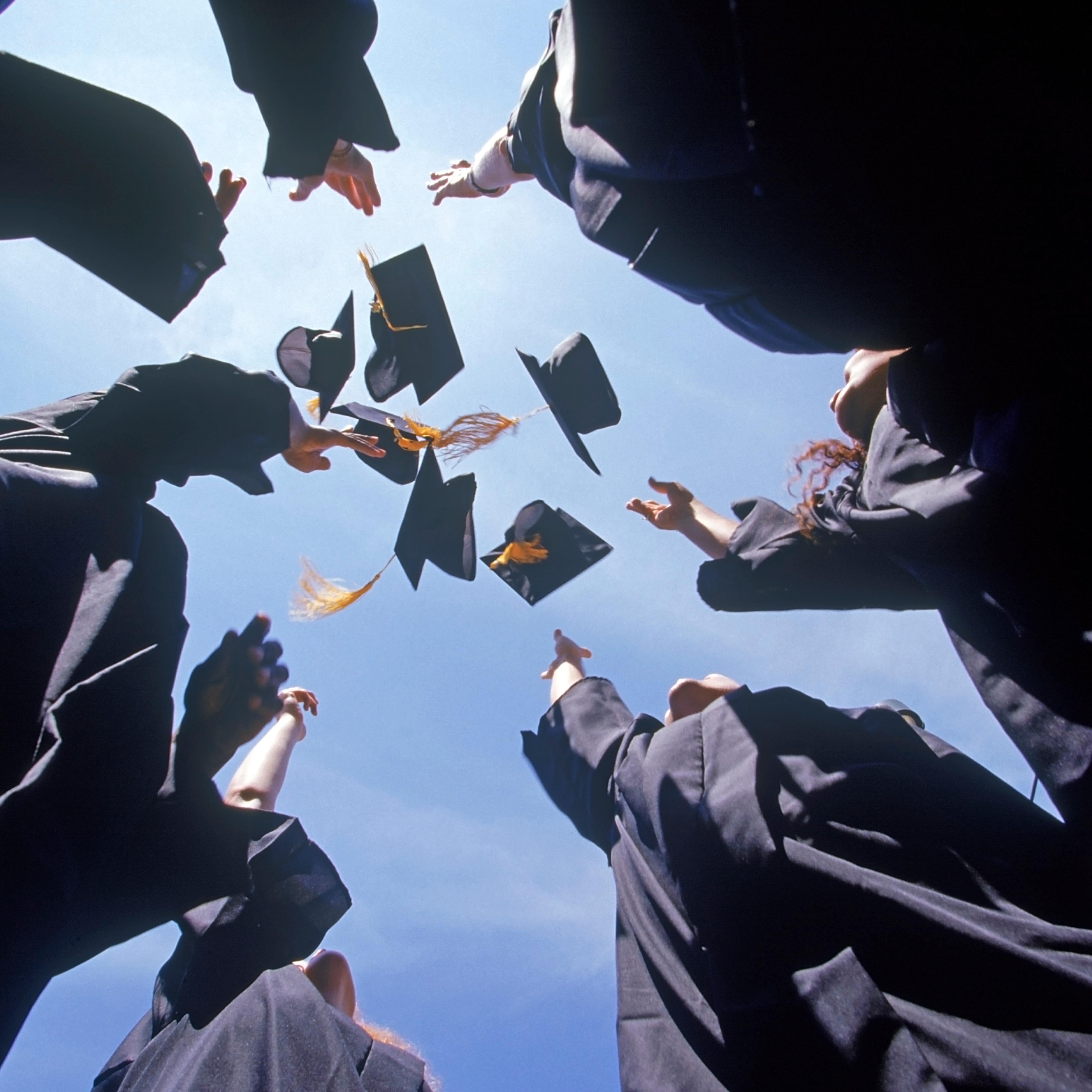 Graduates throwing their caps into the air
