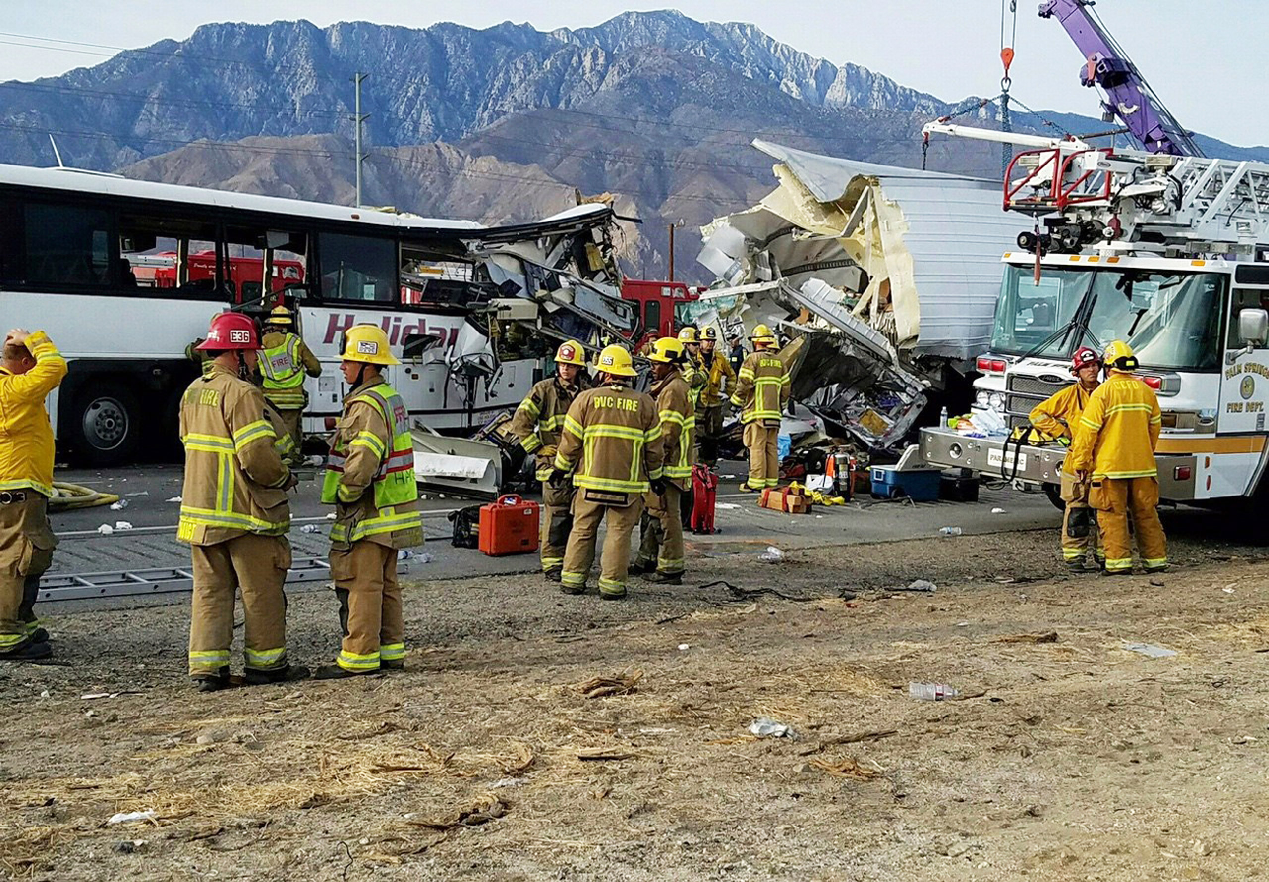 This photo provided by KMIR-TV shows the scene of crash between a tour bus and a semi-truck crashed on Interstate 10 near Desert Hot Springs, near Palm Springs, in California's Mojave Desert Sunday, Oct. 23, 2016. Multiple deaths and injuries were report