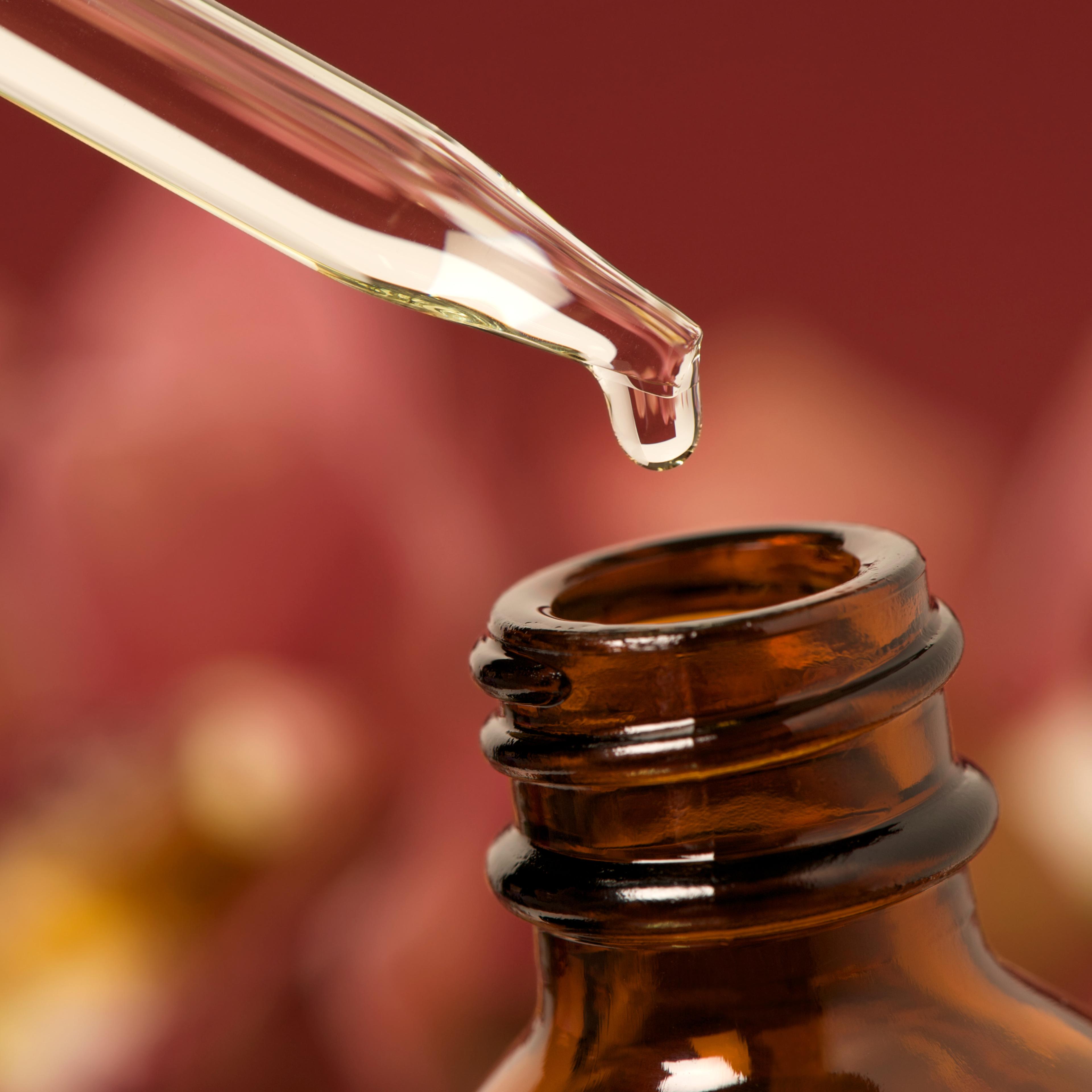 Essential oils with dropper above bottle