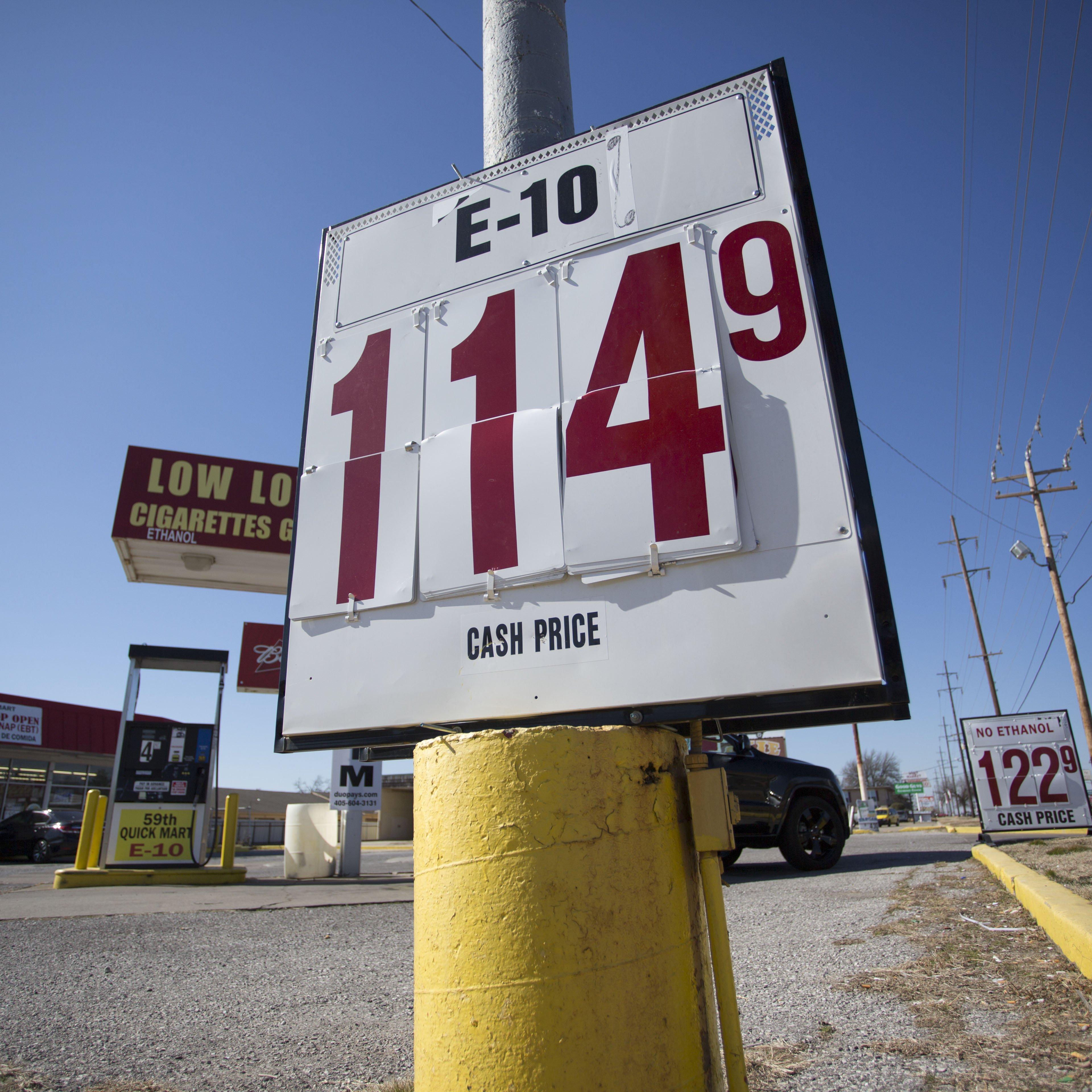 Signs in front of a gas station reflect lower gas prices in Oklahoma City on Feb. 12, 2016.