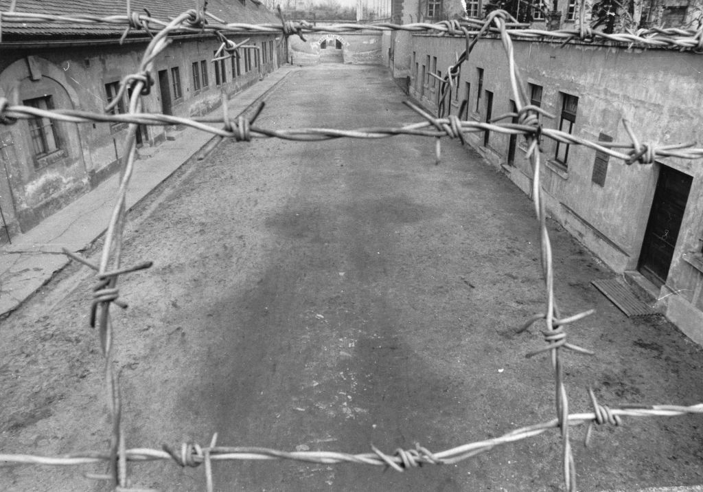View Of The First Courtyard Of The Small Fortress Of The Concentration Camp Theresienstadt. In The Background The Phrase Arbeit Macht Frei -Work Makes -You- Free- Placed Over The Entrance.  Terezín. About 1960. Photograph.
