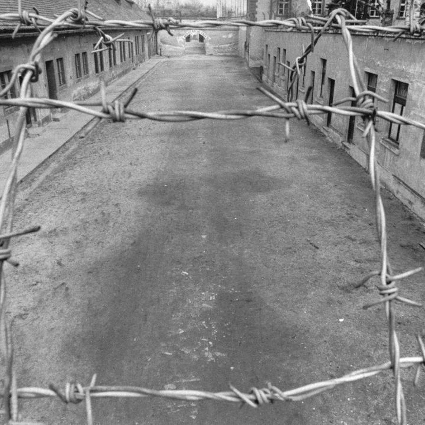View Of The First Courtyard Of The Small Fortress Of The Concentration Camp Theresienstadt. In The Background The Phrase Arbeit Macht Frei -Work Makes -You- Free- Placed Over The Entrance. Terezín. About 1960. Photograph.