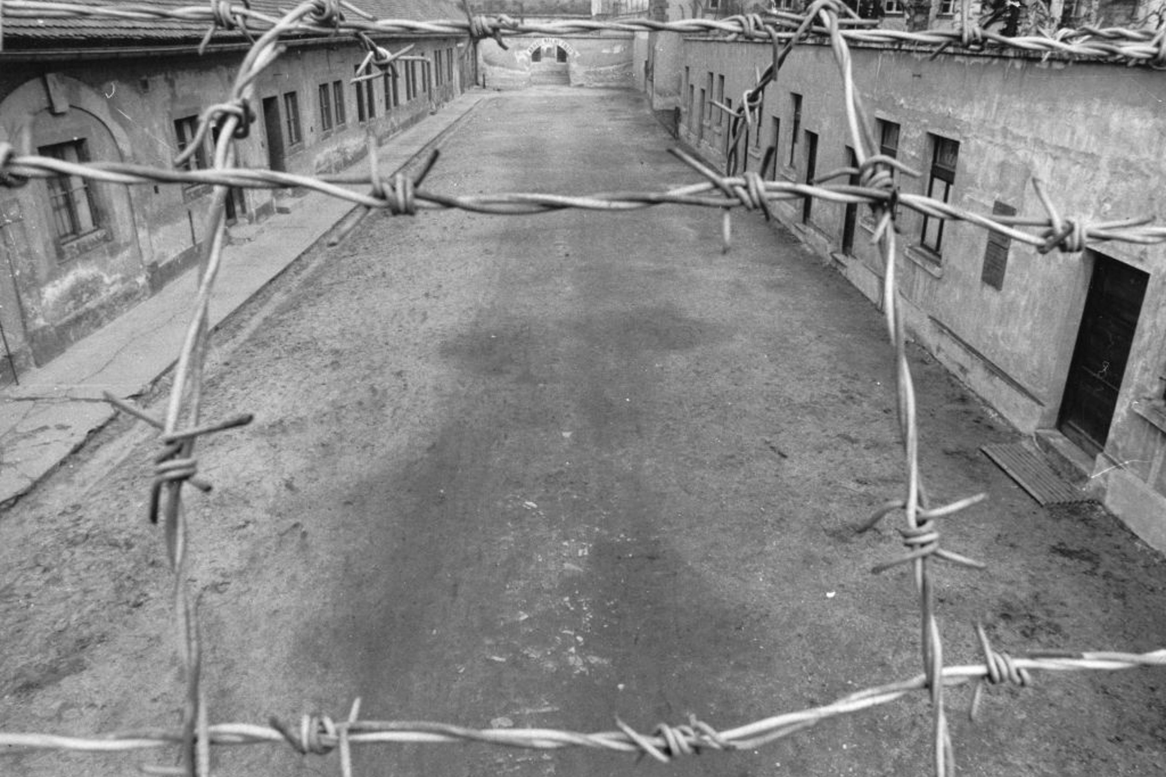 View Of The First Courtyard Of The Small Fortress Of The Concentration Camp Theresienstadt. In The Background The Phrase Arbeit Macht Frei -Work Makes -You- Free- Placed Over The Entrance. Terezín. About 1960. Photograph.