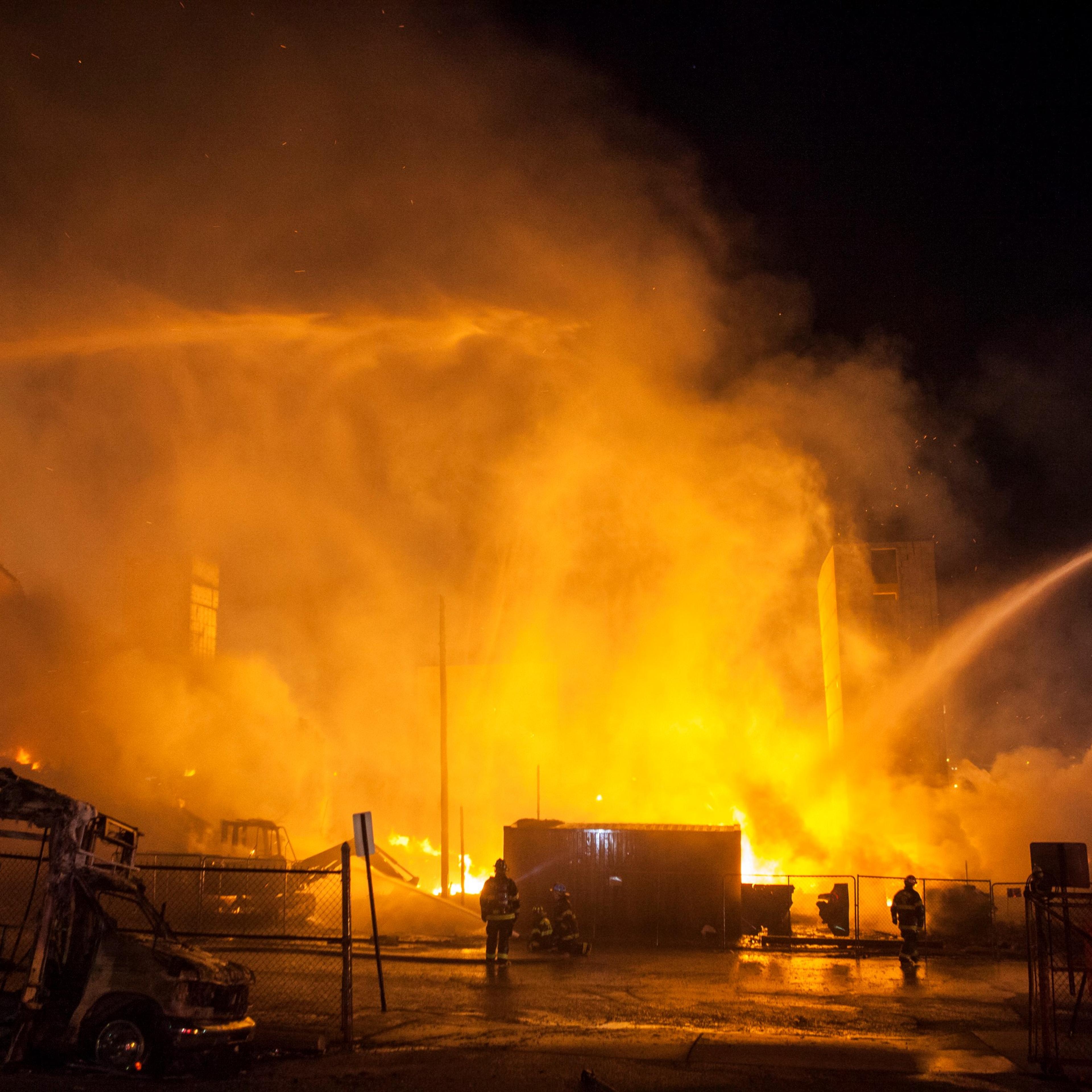 BALTIMORE, USA - APRIL 27: Fire Fighter attempt to put out a building that was set on fire during riots in Baltimore, on April 27, 2015. Protests following the death of Freddie Gray from injuries suffered while in police custody have turned violent.