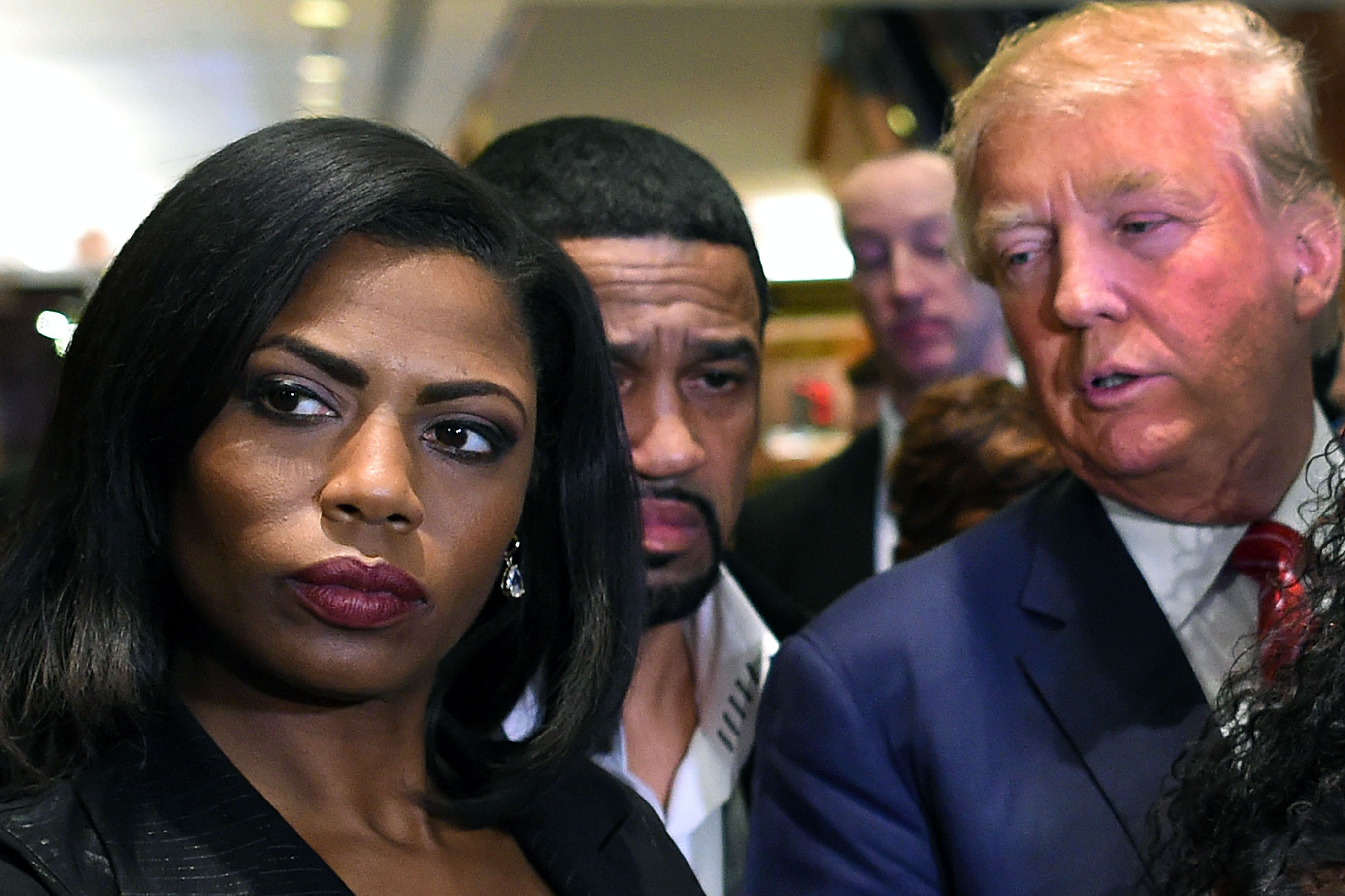 Omarosa Manigault, left, who was a contestant on the first season of Donald Trump's "The Apprentice" and is now an ordained minister, appears alongside Republican presidential candidate Donald Trump during a news conference on Nov. 30, 2015.
