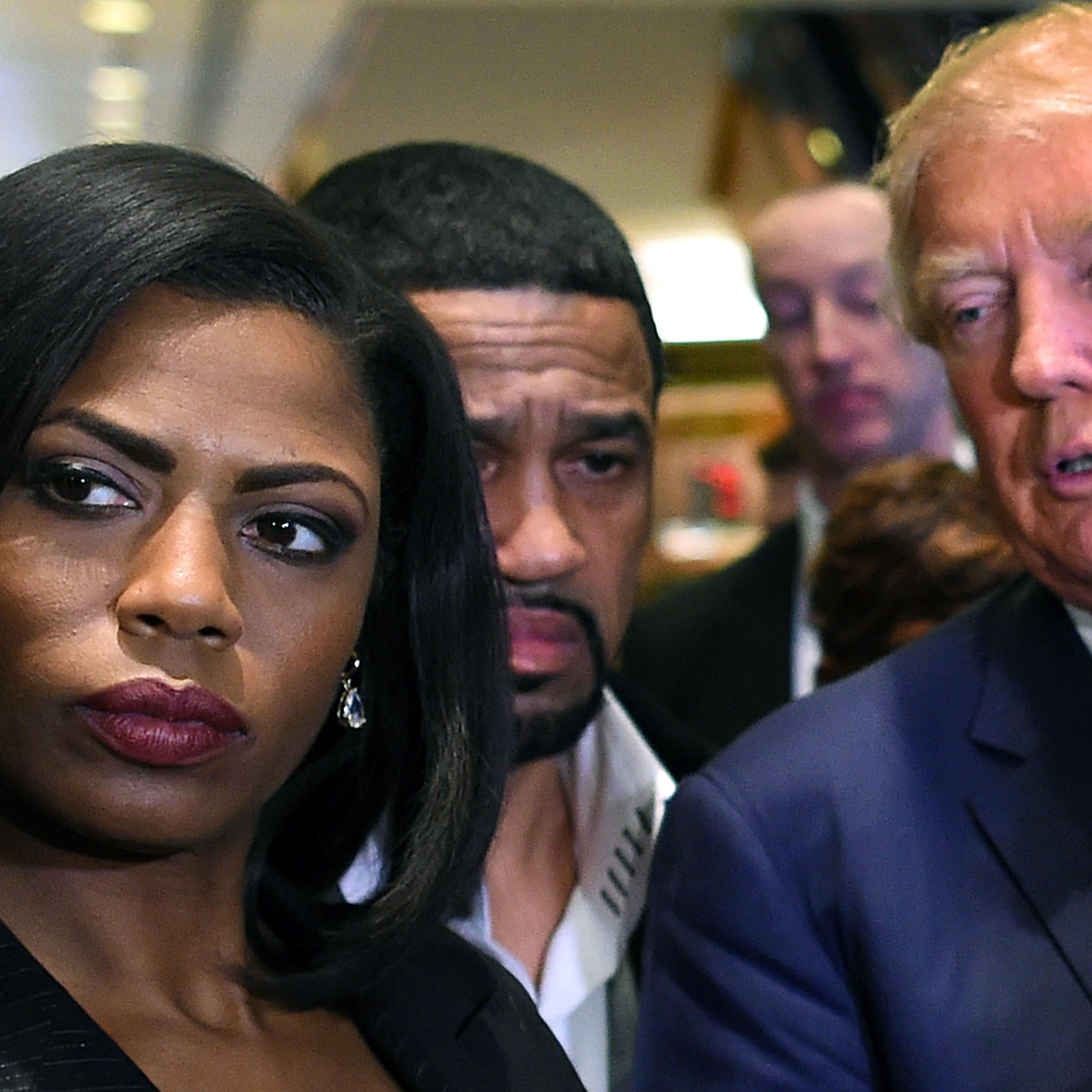 Omarosa Manigault, left, who was a contestant on the first season of Donald Trump's "The Apprentice" and is now an ordained minister, appears alongside Republican presidential candidate Donald Trump during a news conference on Nov. 30, 2015.
