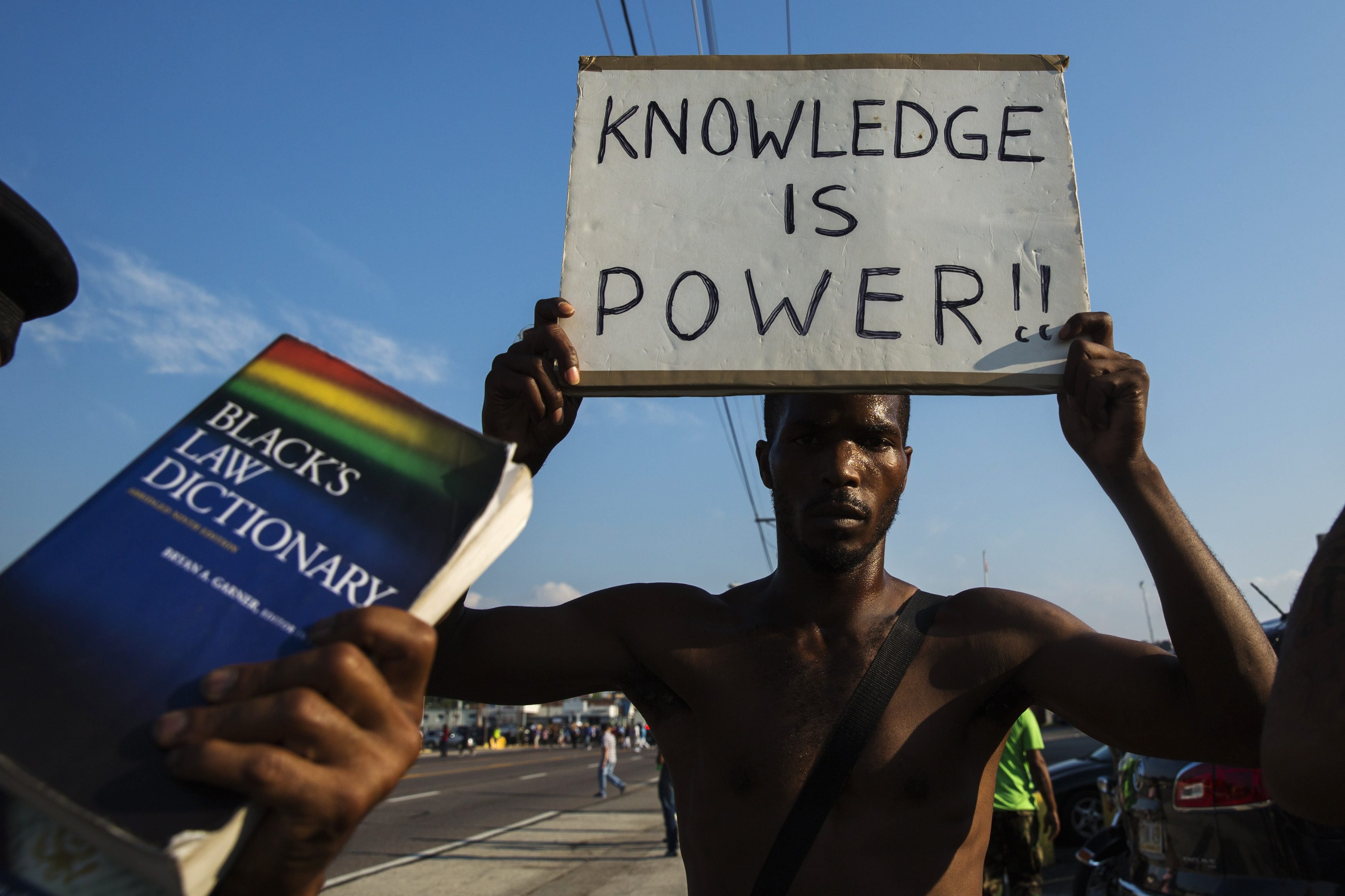 Demonstrators march down West Florissant during a peaceful march in reaction to the shooting of Michael Brown near Ferguson, Missouri