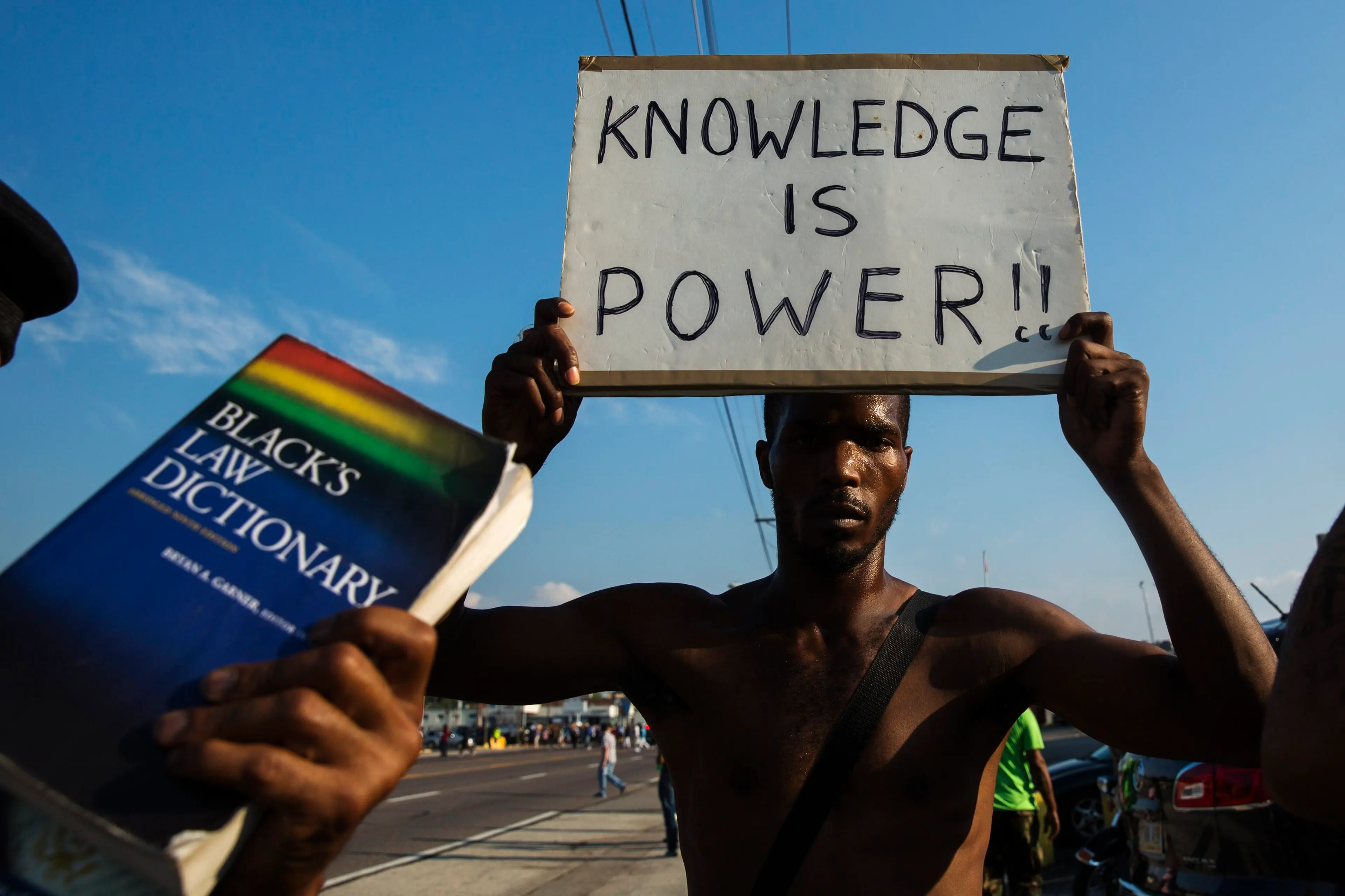 Demonstrators march down West Florissant during a peaceful march in reaction to the shooting of Michael Brown near Ferguson, Missouri