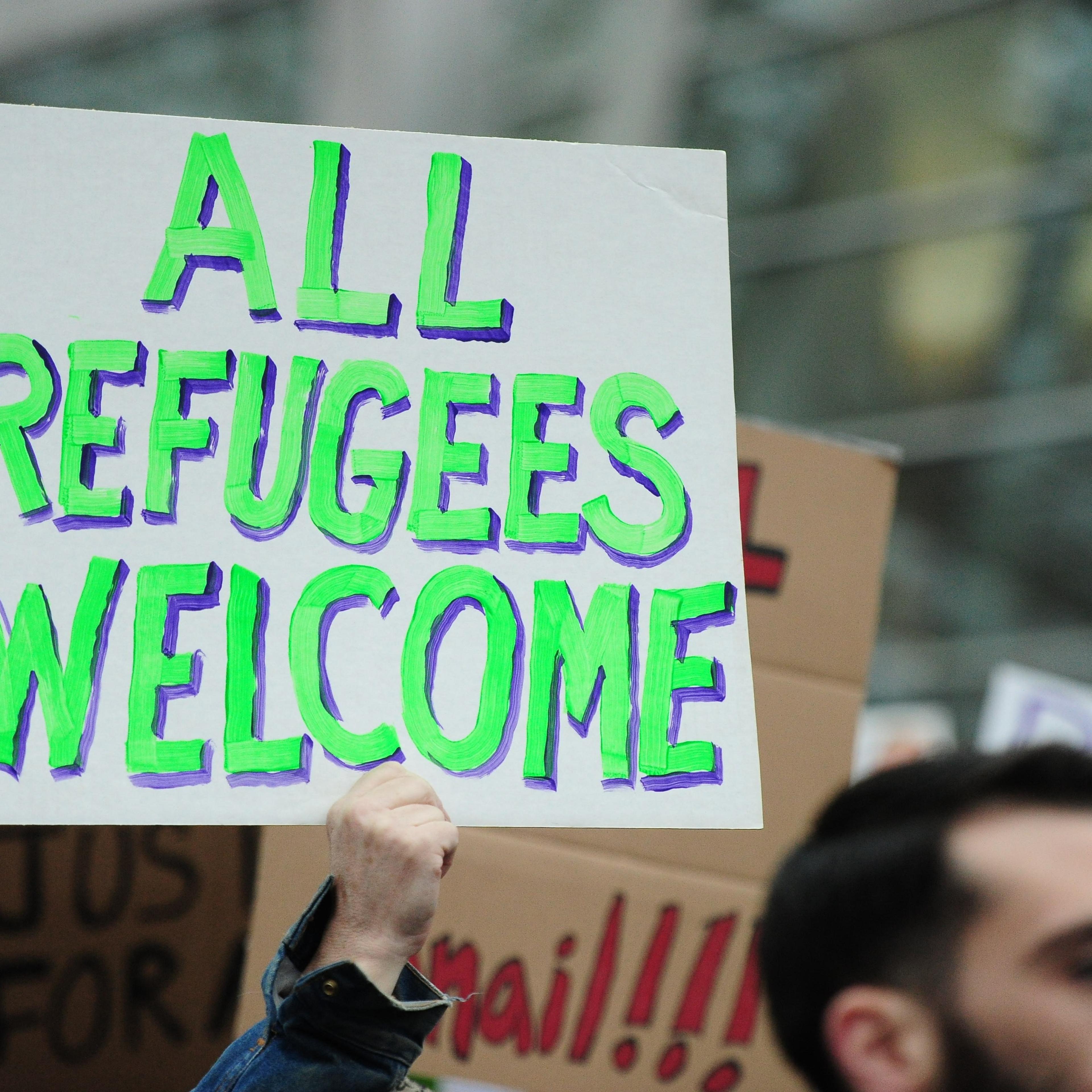 A protester holds a banner during a demonstration against President Trump's immigration ban at Portland International Airport in Portland, United States on January 29, 2017.