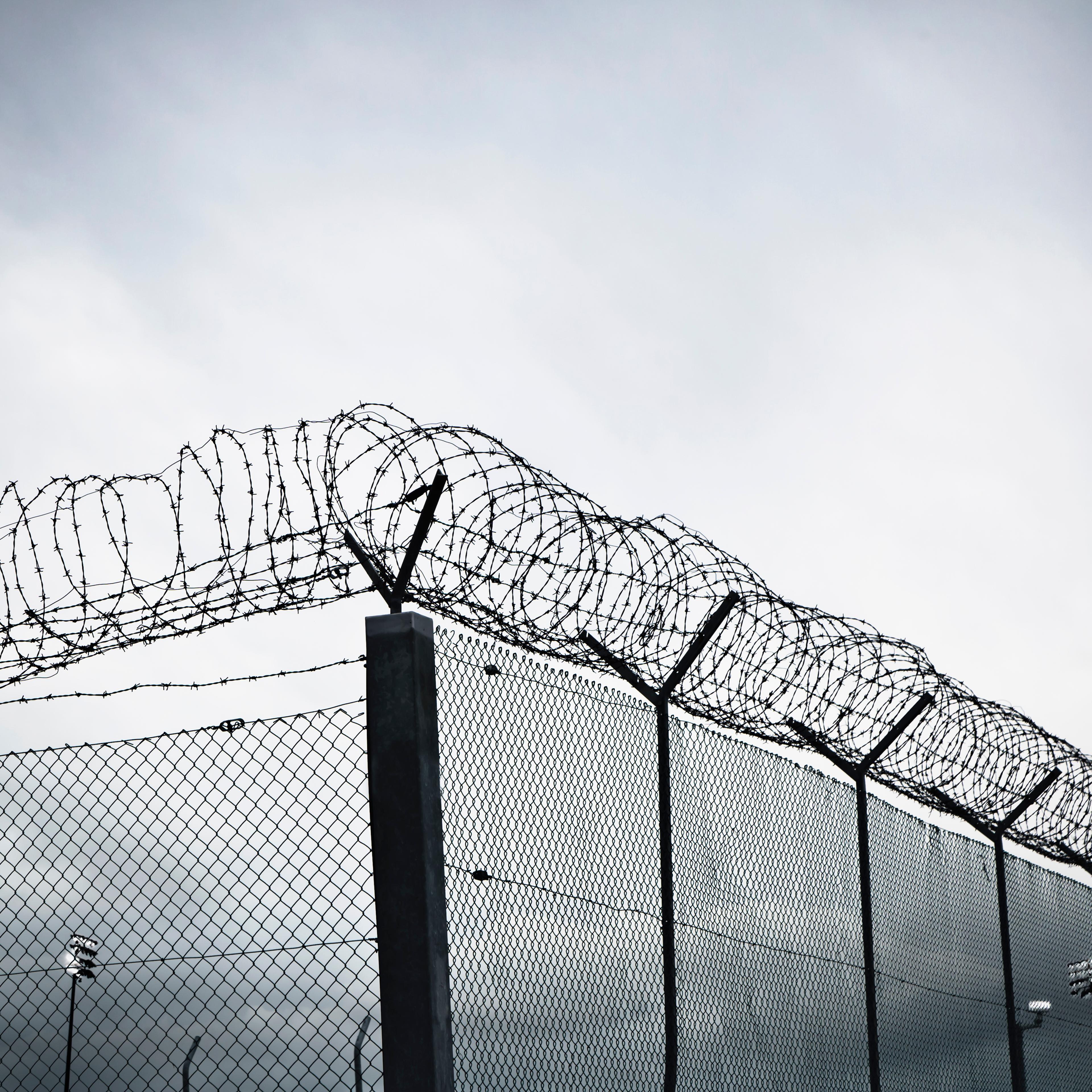 Chain link fence with barbed wire and razor wire