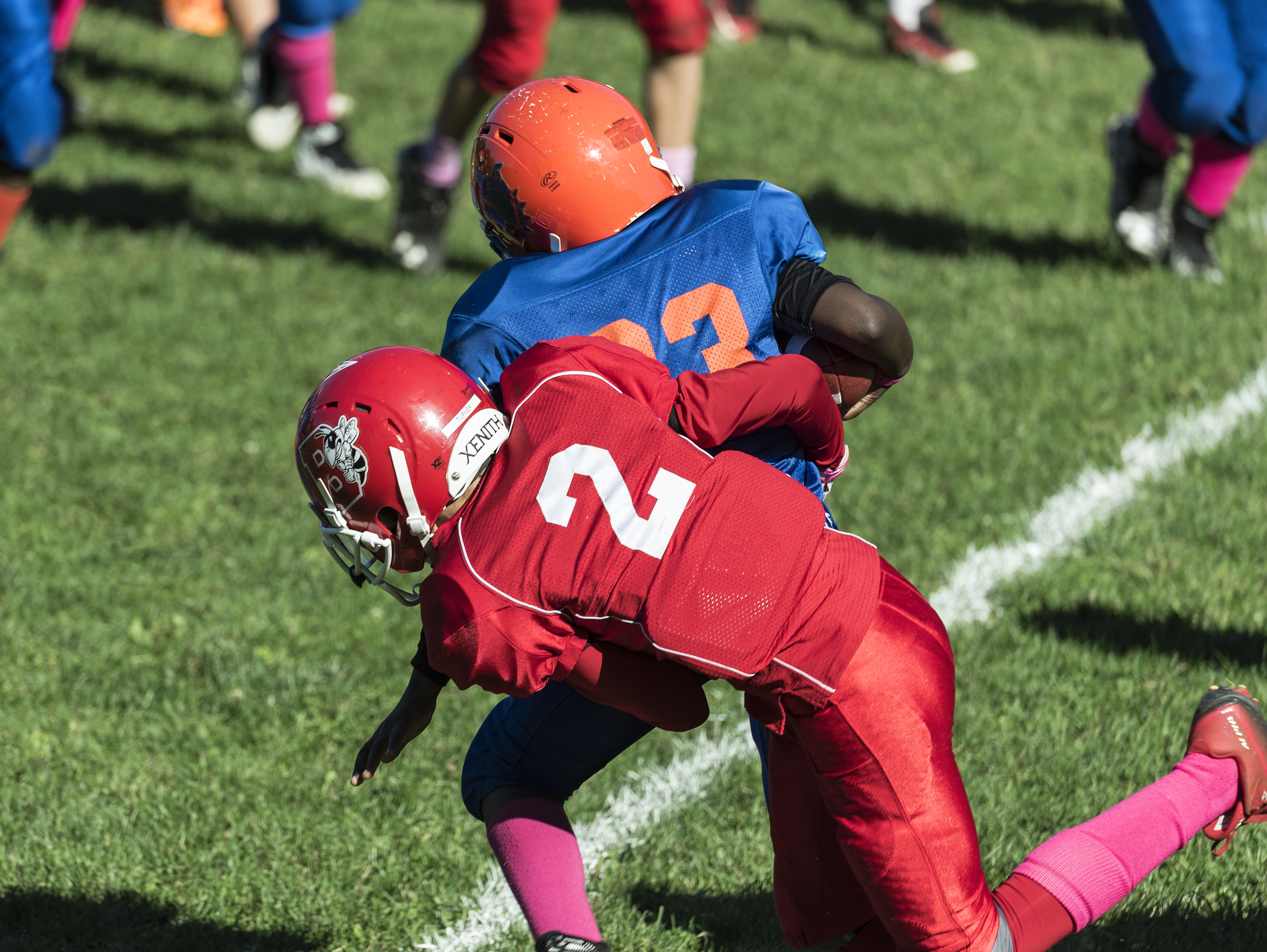 Making a tackle during a Pop Warner football game