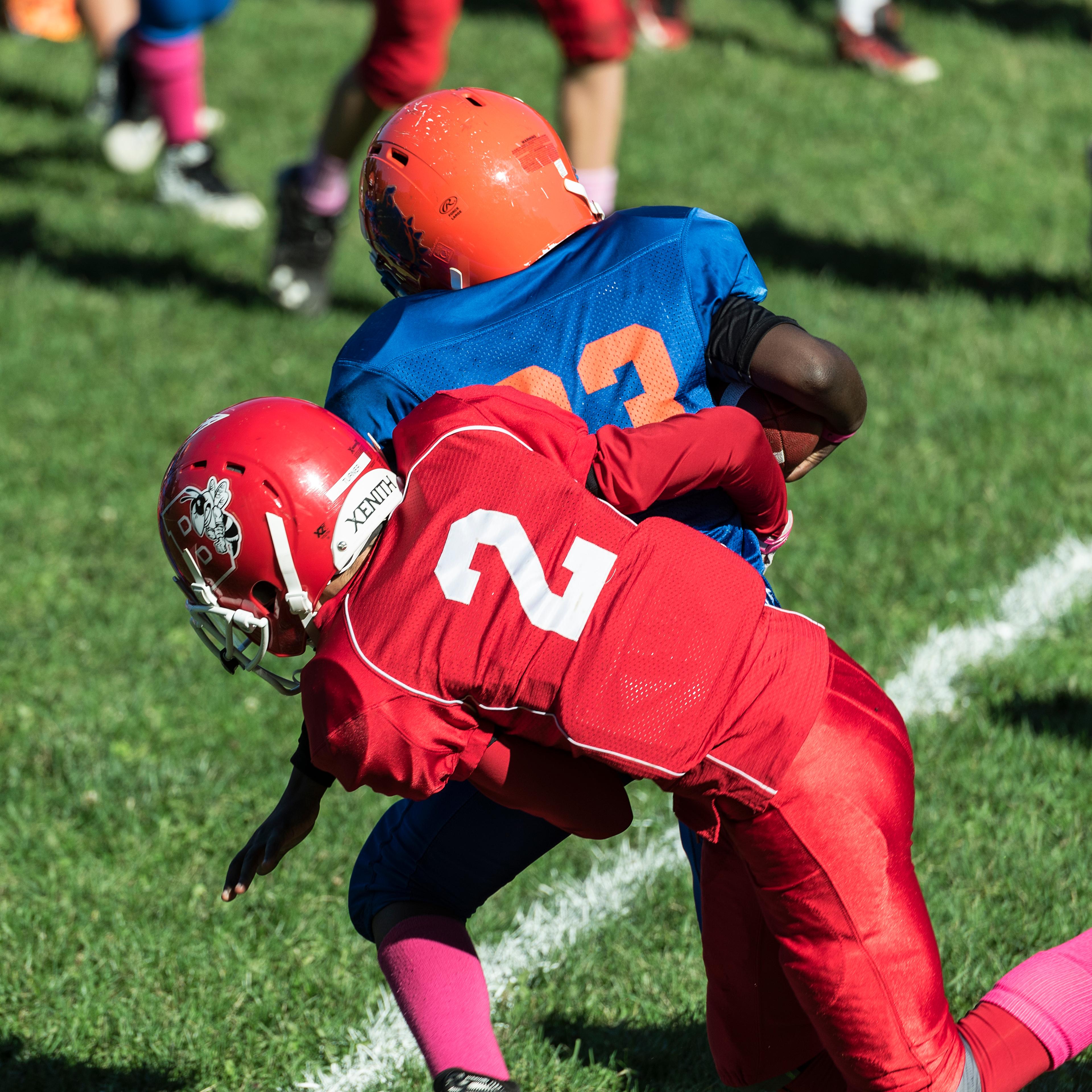 Making a tackle during a Pop Warner football game