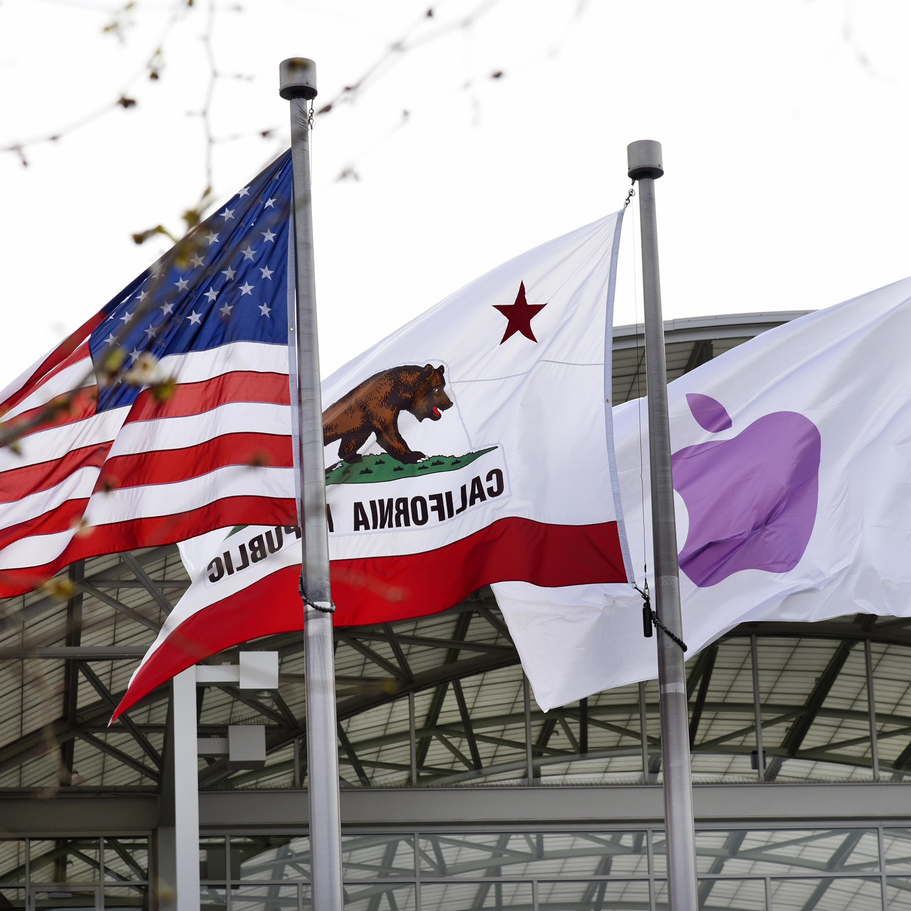 Apple Inc., California Repulbic, and American flags fly outside of company headquarters during an Apple event in Cupertino, California, U.S., on Monday, March 21, 2016.