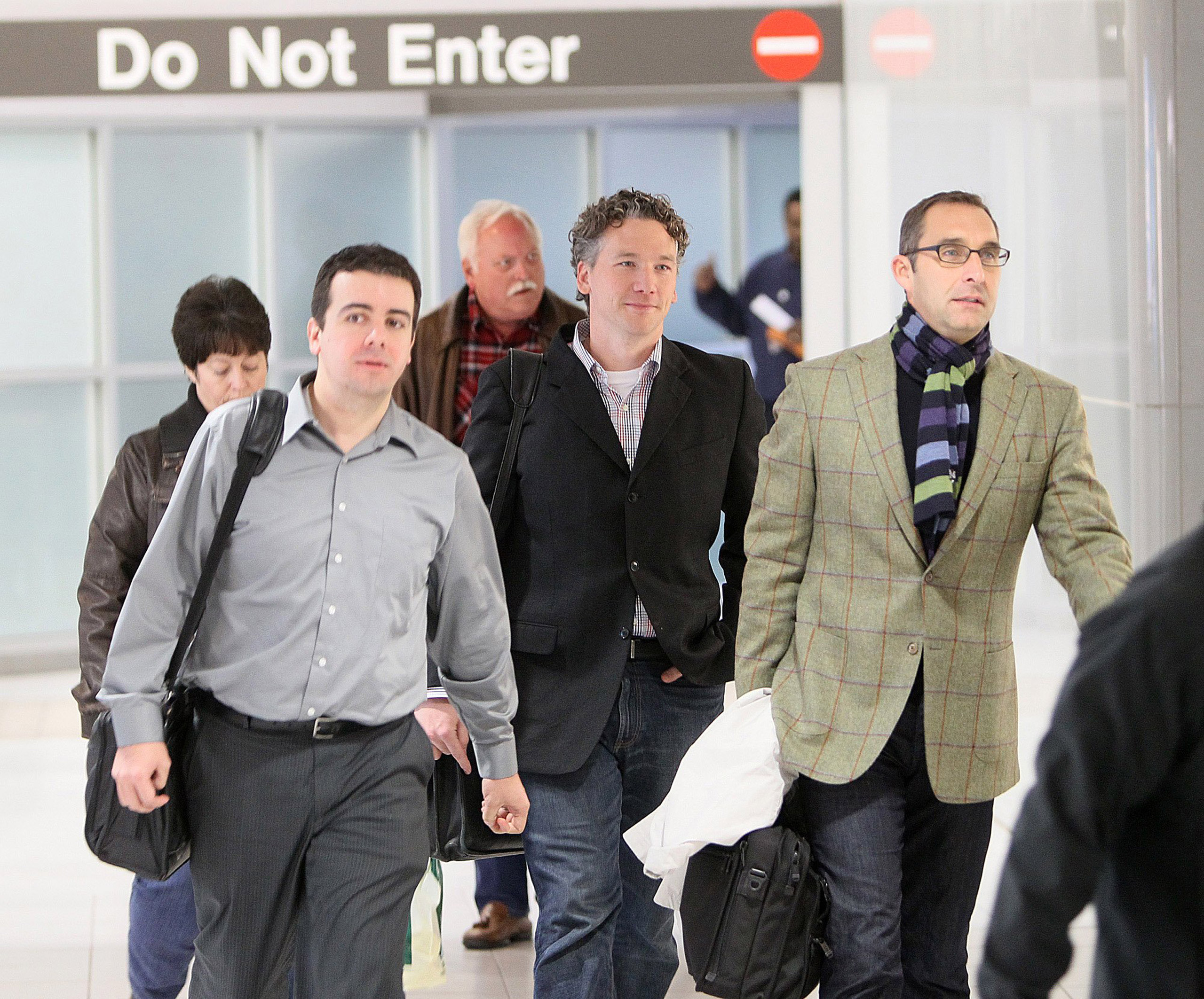 In this Dec. 8, 2011, photo, then-St. Louis Cardinals scouting director Christopher Correa, left, assistant general manager Mike Girsch, center, and general manager John Mozeliak, right, arrive at Lambert-St. Louis International Airport in St. Louis, Mo.