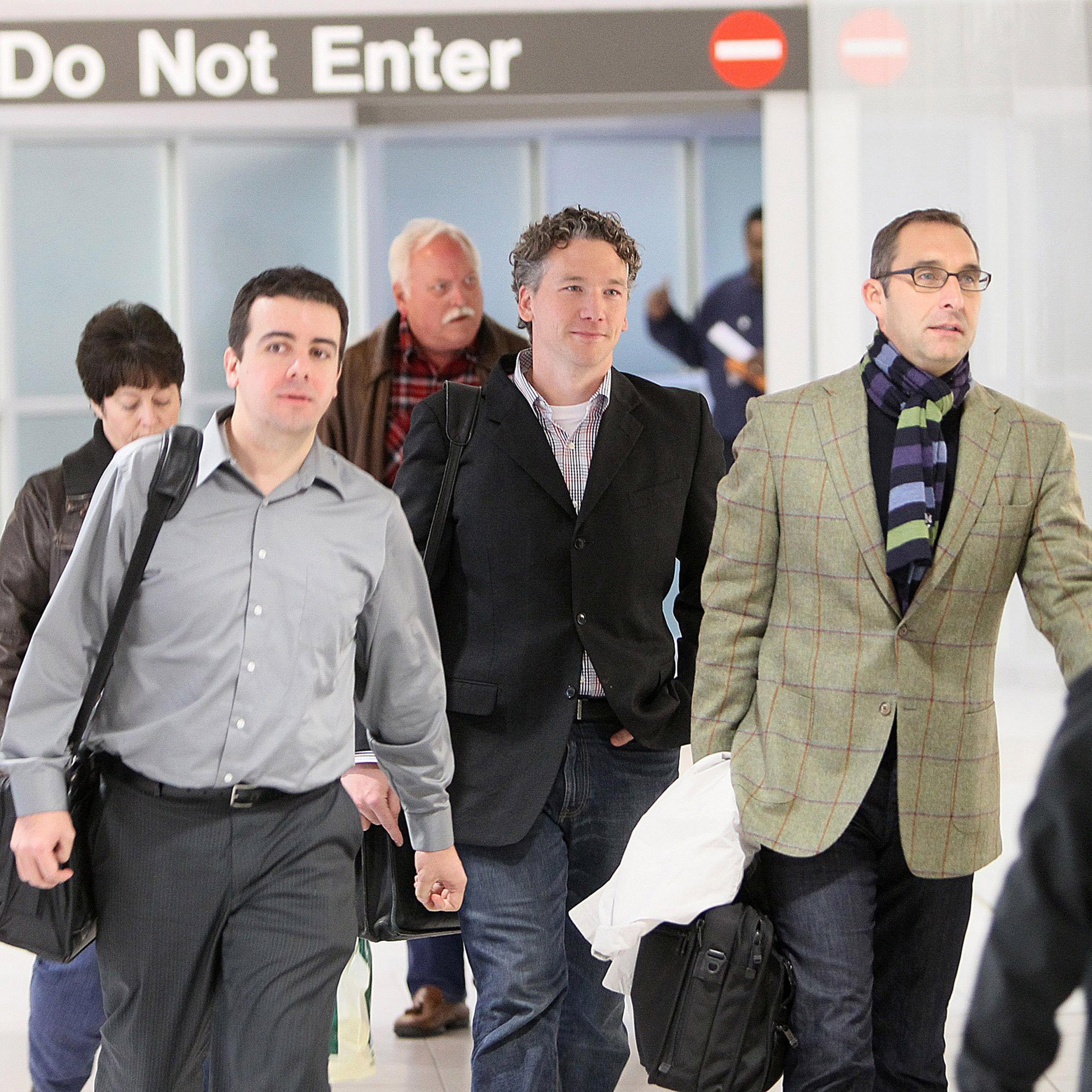 In this Dec. 8, 2011, photo, then-St. Louis Cardinals scouting director Christopher Correa, left, assistant general manager Mike Girsch, center, and general manager John Mozeliak, right, arrive at Lambert-St. Louis International Airport in St. Louis, Mo.