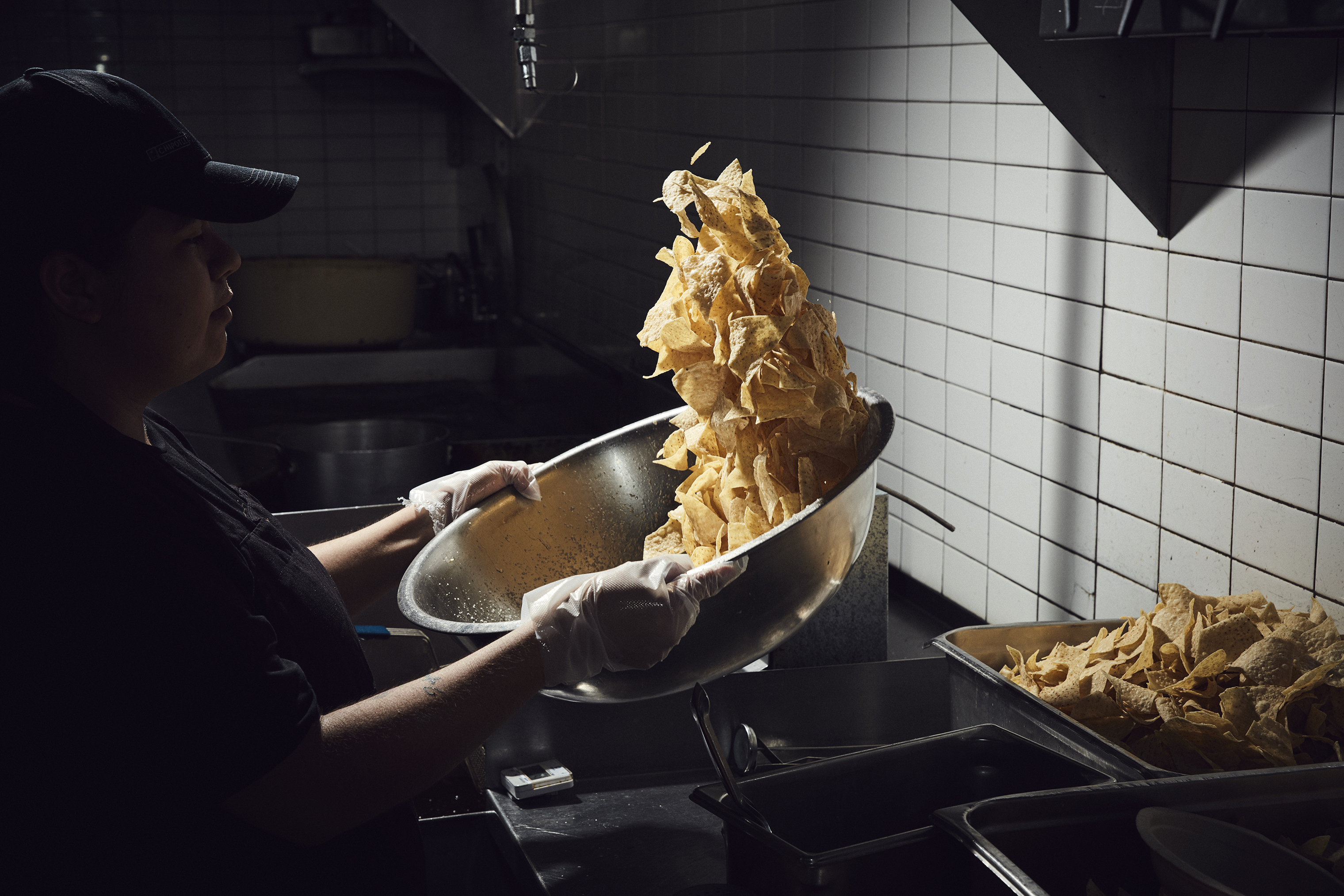 A Chipotle employee seasons chips at a location in Newport Beach, Calif. The company, founded in 1993, now has roughly 70,000 employees and 2,450 locations.