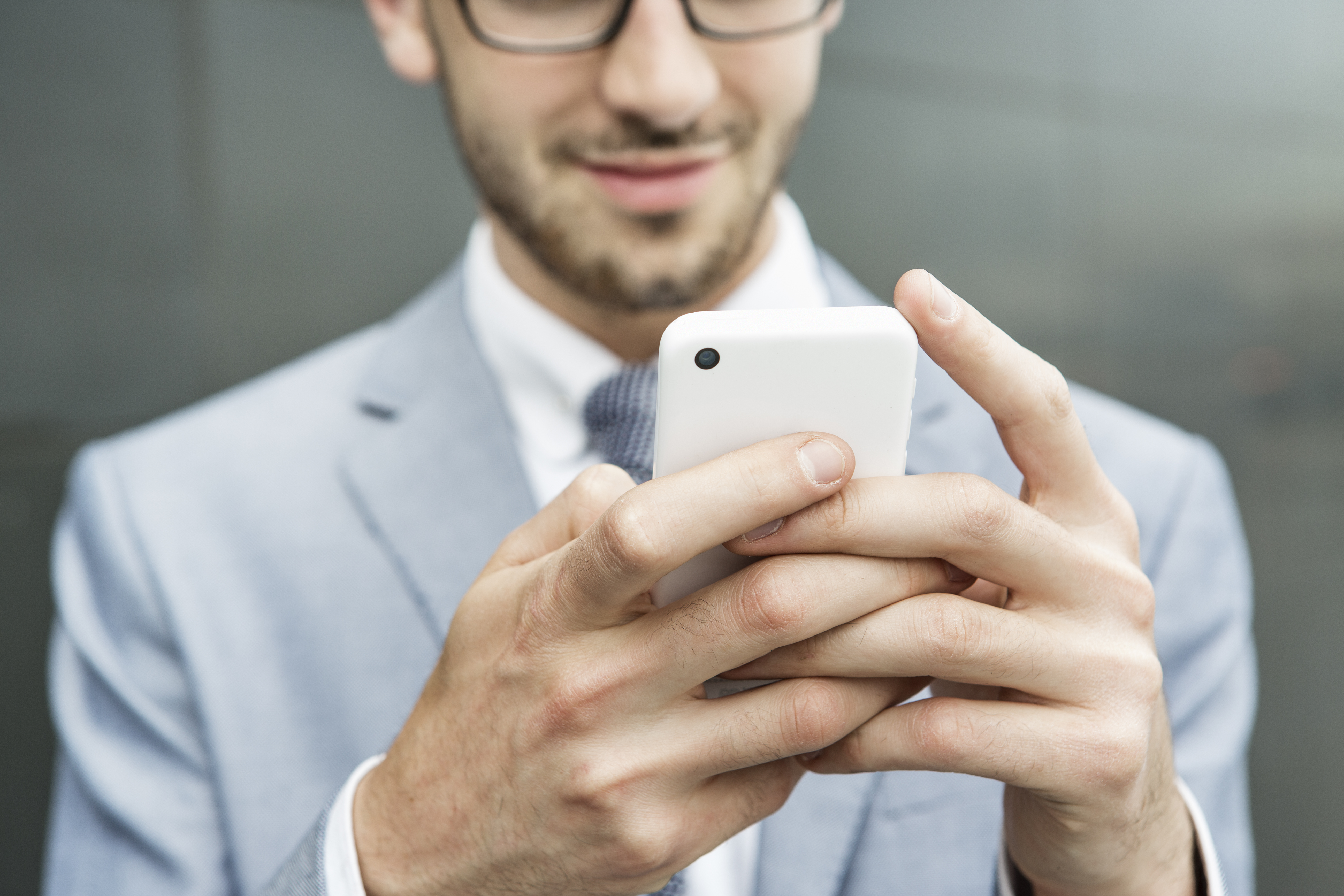 Businessman holding mobile phone.