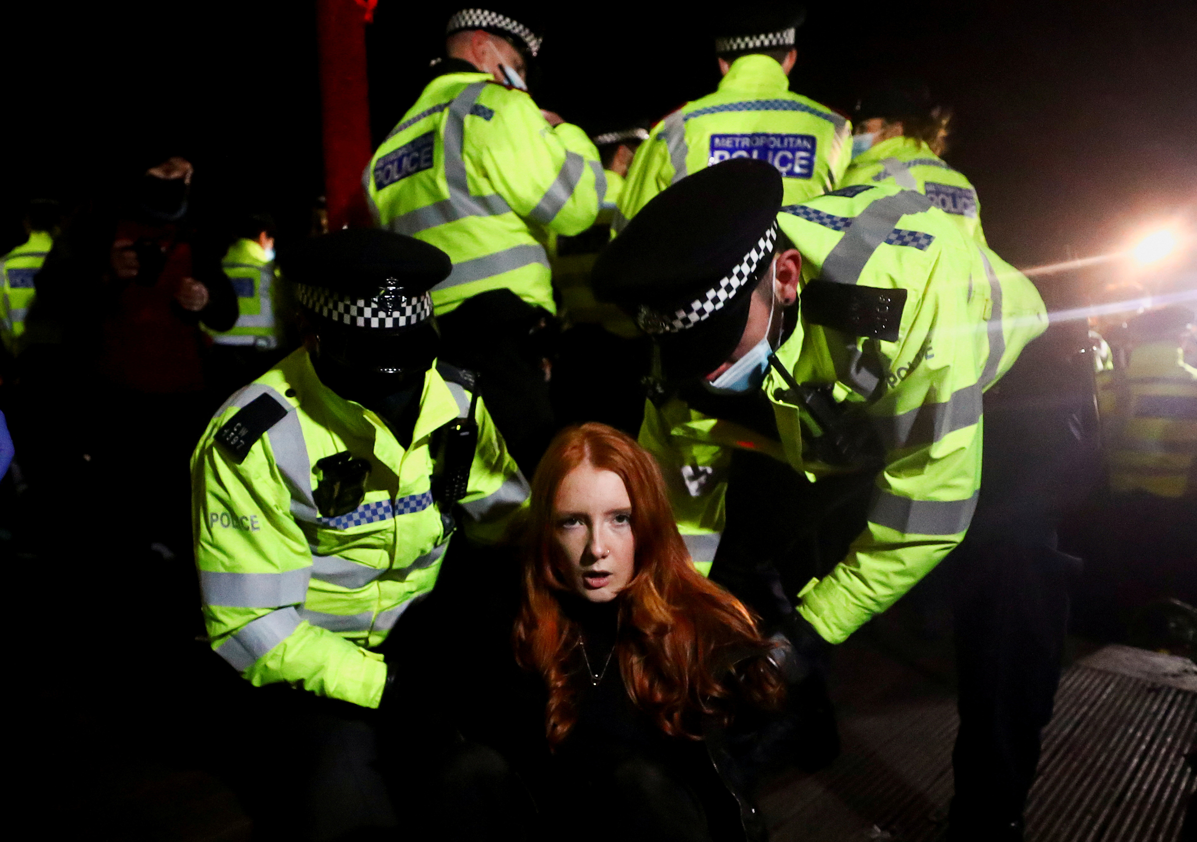 Police detain Patsy Stevenson as people gather at a memorial site in Clapham Common Bandstand, following the kidnap and murder of Sarah Everard, in London on March 13