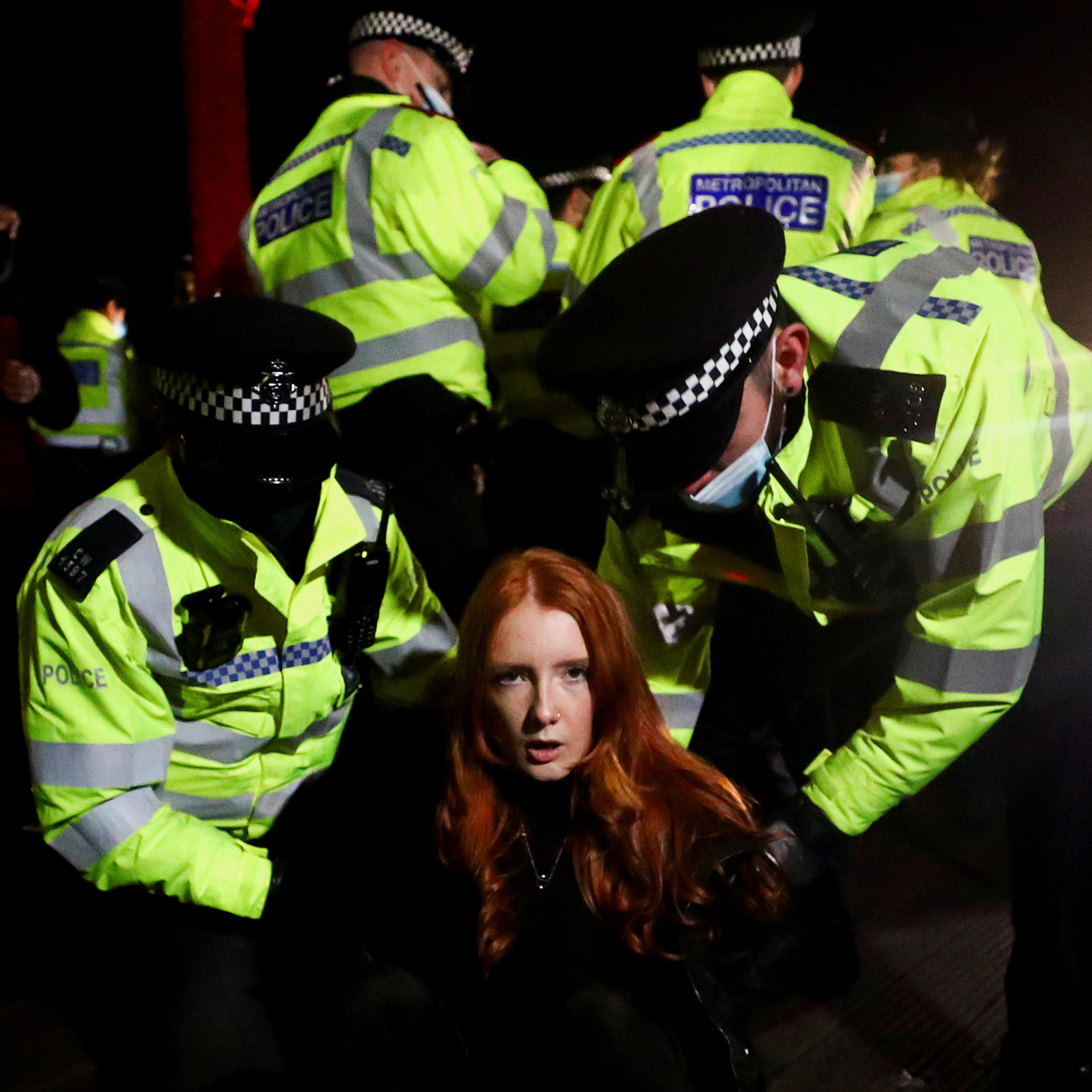 Police detain Patsy Stevenson as people gather at a memorial site in Clapham Common Bandstand, following the kidnap and murder of Sarah Everard, in London on March 13