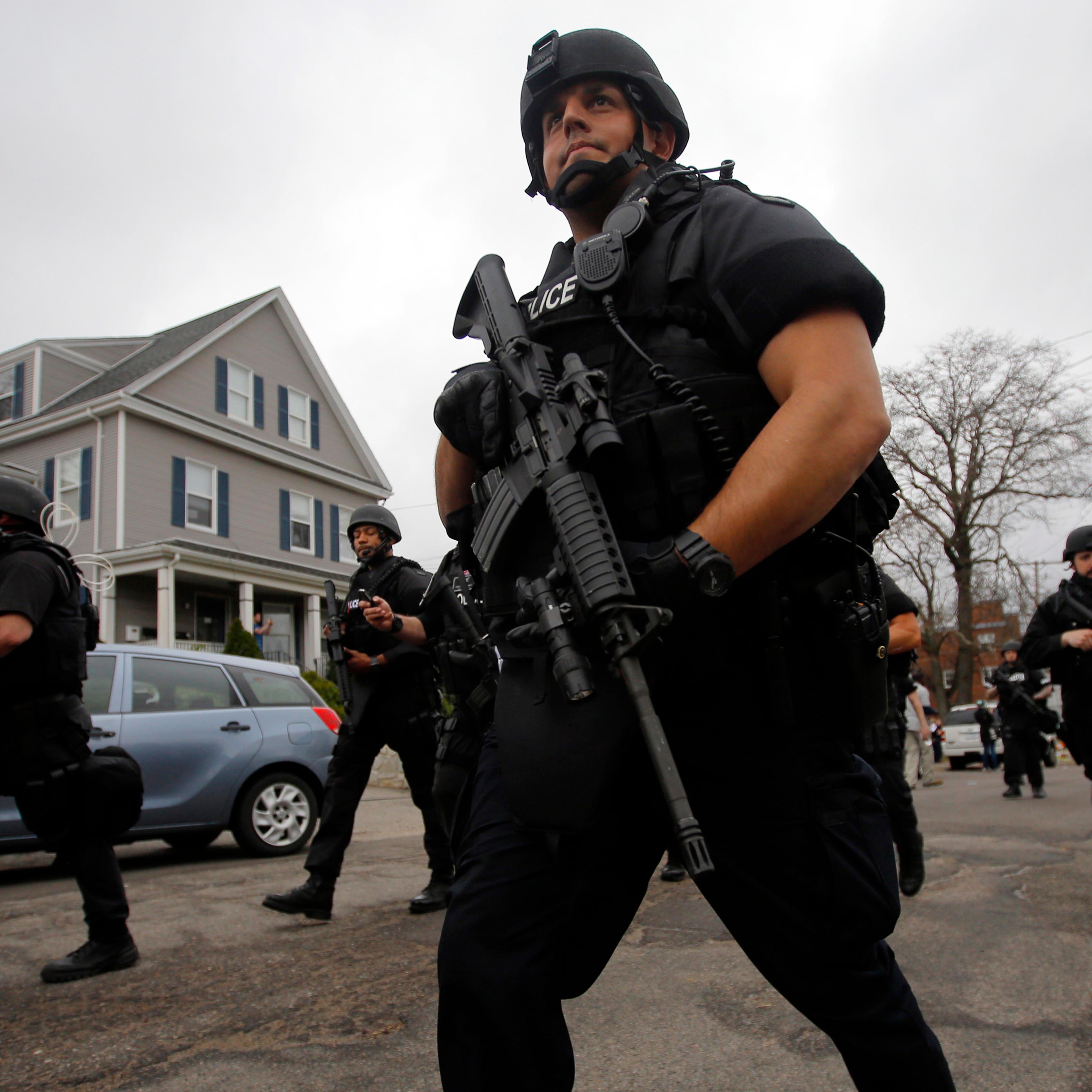 Police officers searched house to house for Dzhokhar Tsarnaev, the surviving suspect in the Boston Marathon bombings, in a neighborhood in Watertown, Mass., on April 19, 2013.