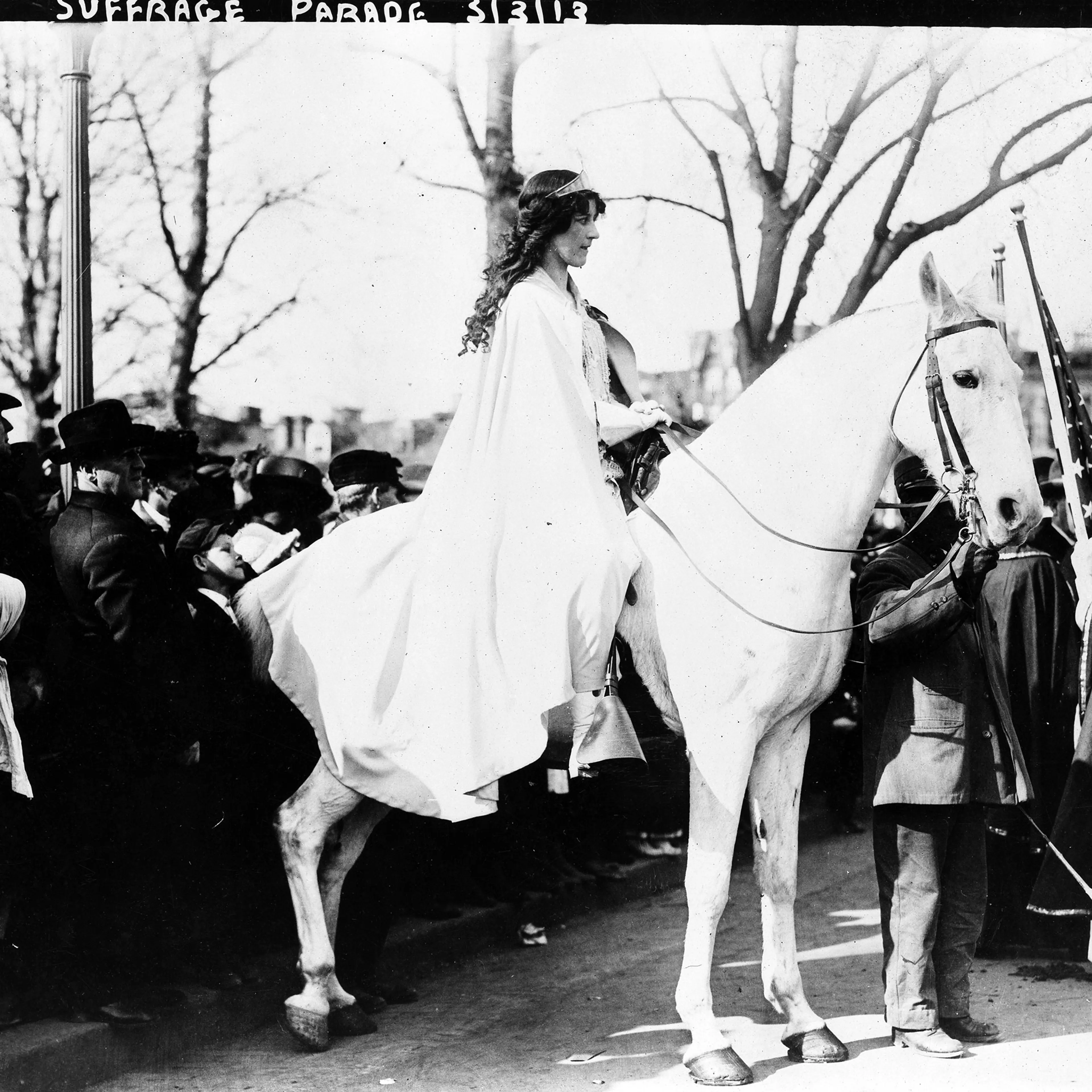 Inez Milholland Boissevain, wearing white cape, seated on white horse at the National American Woman Suffrage Association parade, March 3, 1913, Washington, D.C.
