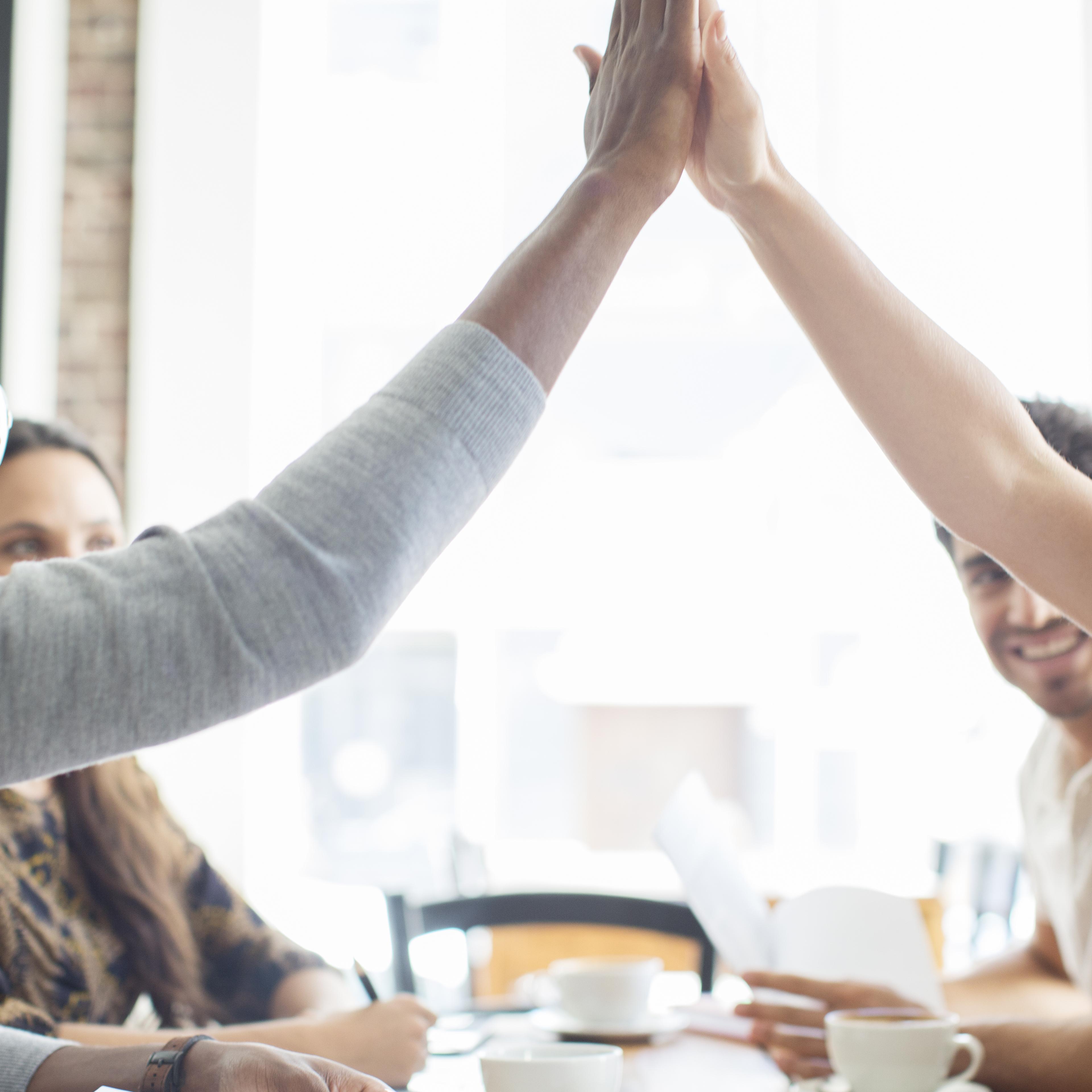 people-cheering-high-five-cafe