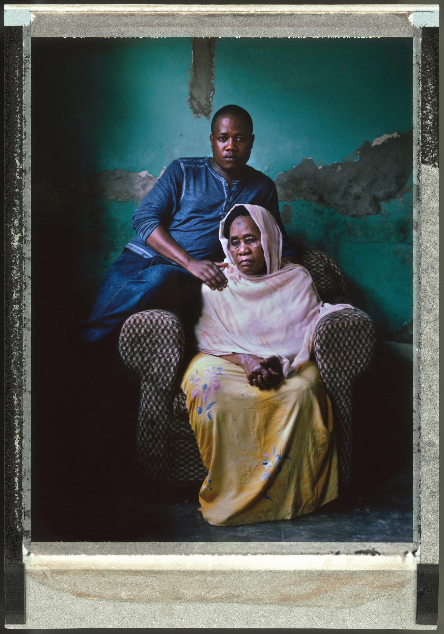 <b>Joseph Kawesi, 31<br>
Uganda, March 2015</b><br>
Joseph Kawesi, a transgender woman, sits at home in the Ugandan capital of Kampala with her mother Mai, 65. <br><br>
Kawesi still has nightmares about the night in December 2012 when she says police officers dragged her out of her home after a tip-off that she might be gay. She says the officers beat her, and then raped her with a club. Kawesi is now an activist working to support LGBT people affected by HIV/AIDS in Uganda.
<br><br>
Uganda's president signed an Anti-Homosexuality Act into law in Feb. 2014, that broadened the criminalization of same-sex relationships, adding to colonial-era laws that already prohibited sodomy. The law was overturned on a technicality in August, but Parliament could pass a new anti-homosexuality bill this year.
