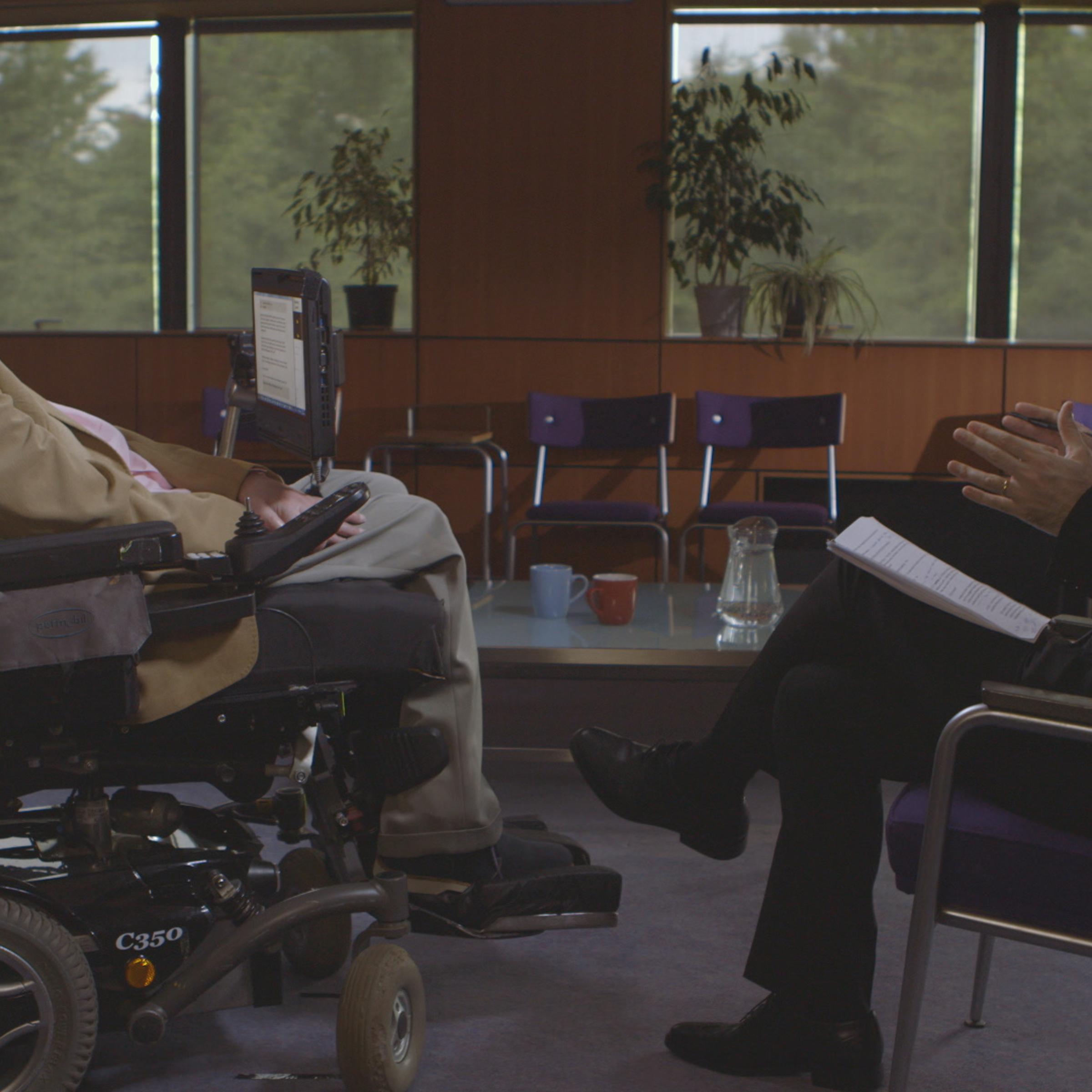 Oliver, at right, interviews Stephen Hawking