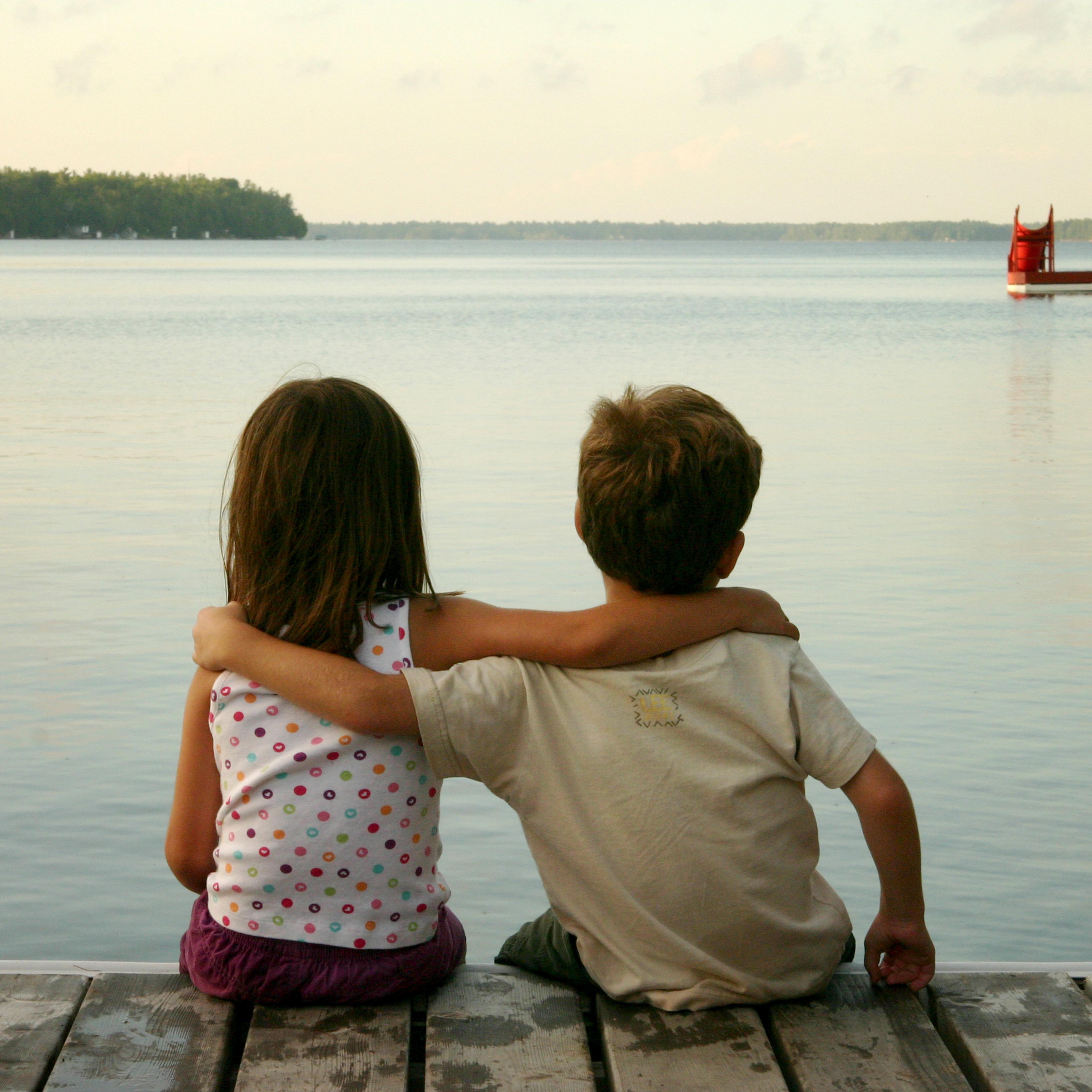 boy-and-girl-sitting-by-lake